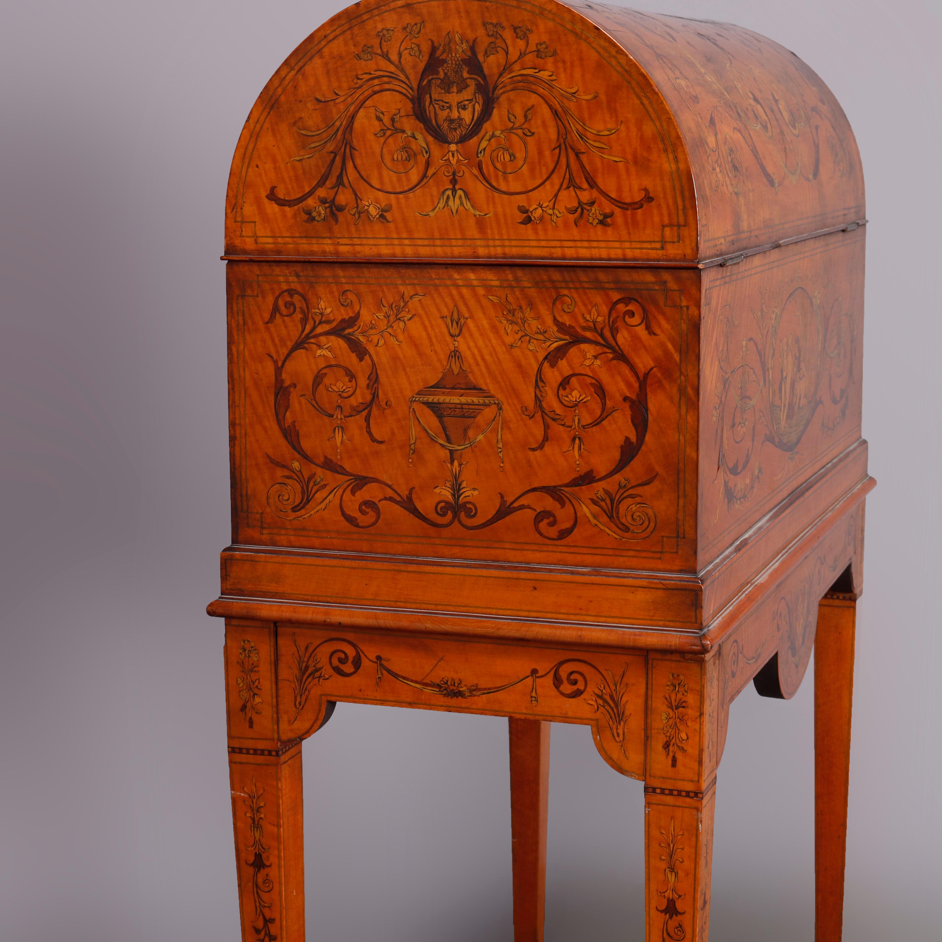 An antique Adam decorated domed chest offers all-over satinwood inlaid scenes of cherubs, urns, scroll and foliate elements, opening to velvet interior and seated on matching inlaid stand with straight and tapered legs, circa 1820

***DELIVERY