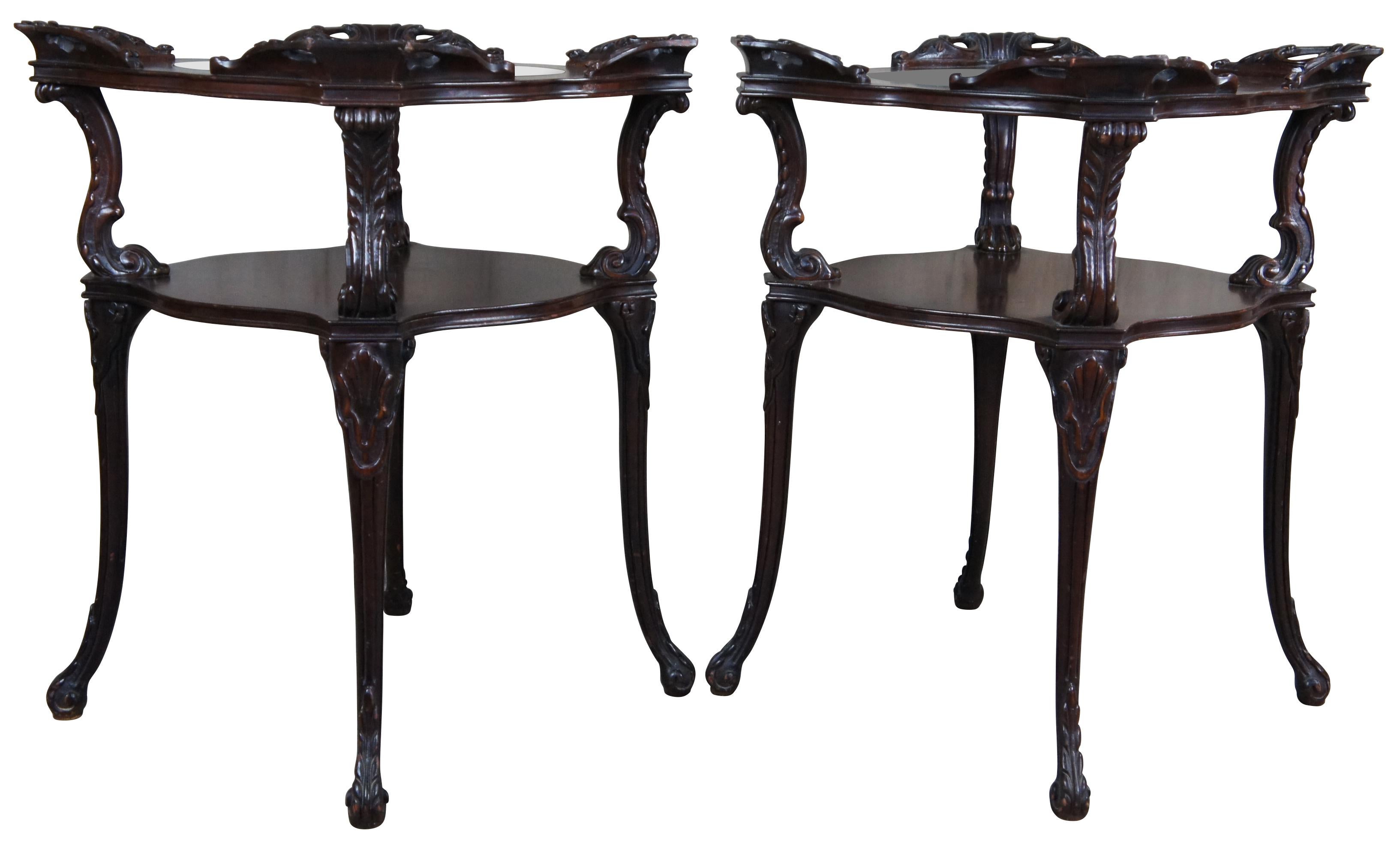 Adams Always Fine Furniture Louis XV style tiered end tables, circa 1930-40s.  Beautifully designed with acanthus and scalloped details. Features an inset round glass top resting on a raised wooden top supported by 