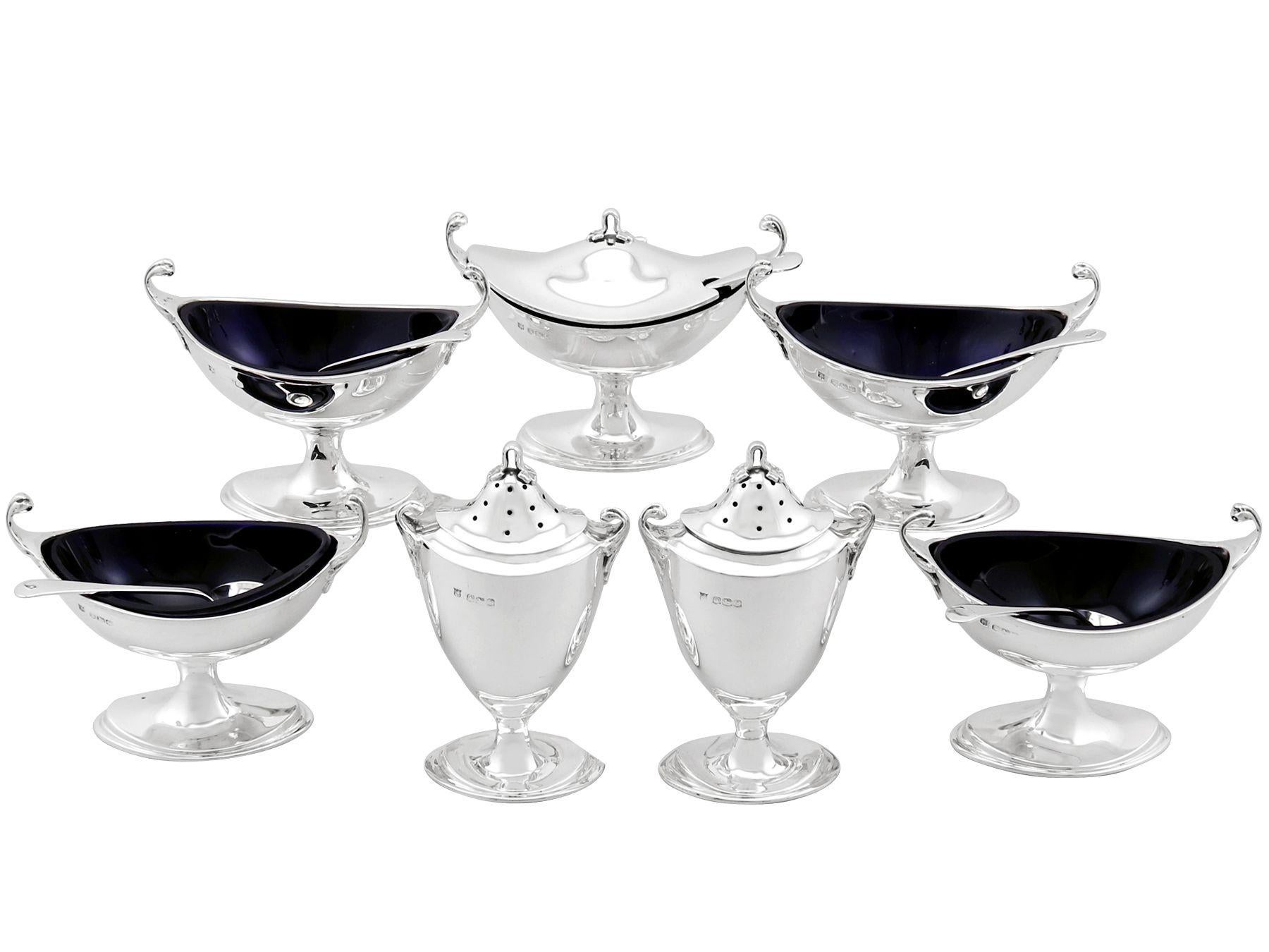 An exceptional, fine and impressive antique George V English sterling silver seven piece condiment / cruet set made in the Adams style - boxed; an addition to our dining silverware collection.

This exceptional antique George V 7 piece condiment set