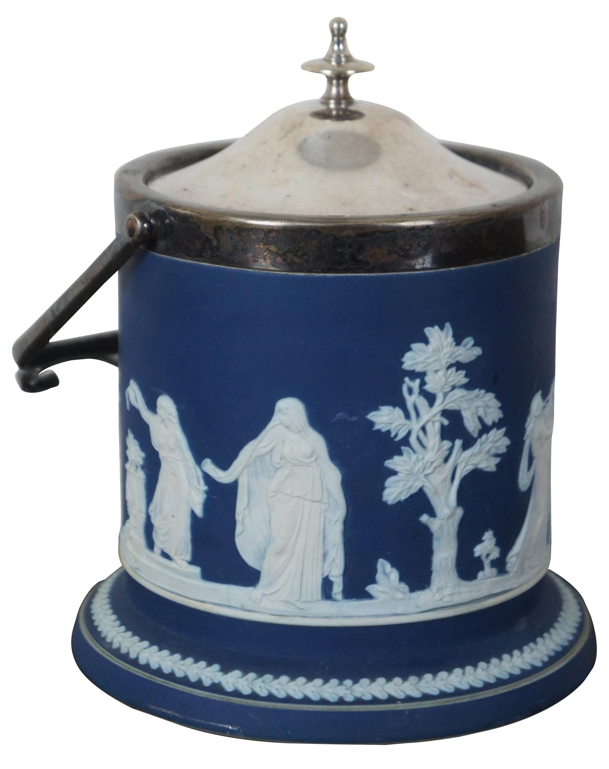 Antique late 19th century Wedgwood style blue and white jasperware biscuit jar by William Adams of Tunstall, England with EPNS silver plate lid and handle by Edwin Blyde and Co, Sheffield.

Measures: Height to top of handle 10”.