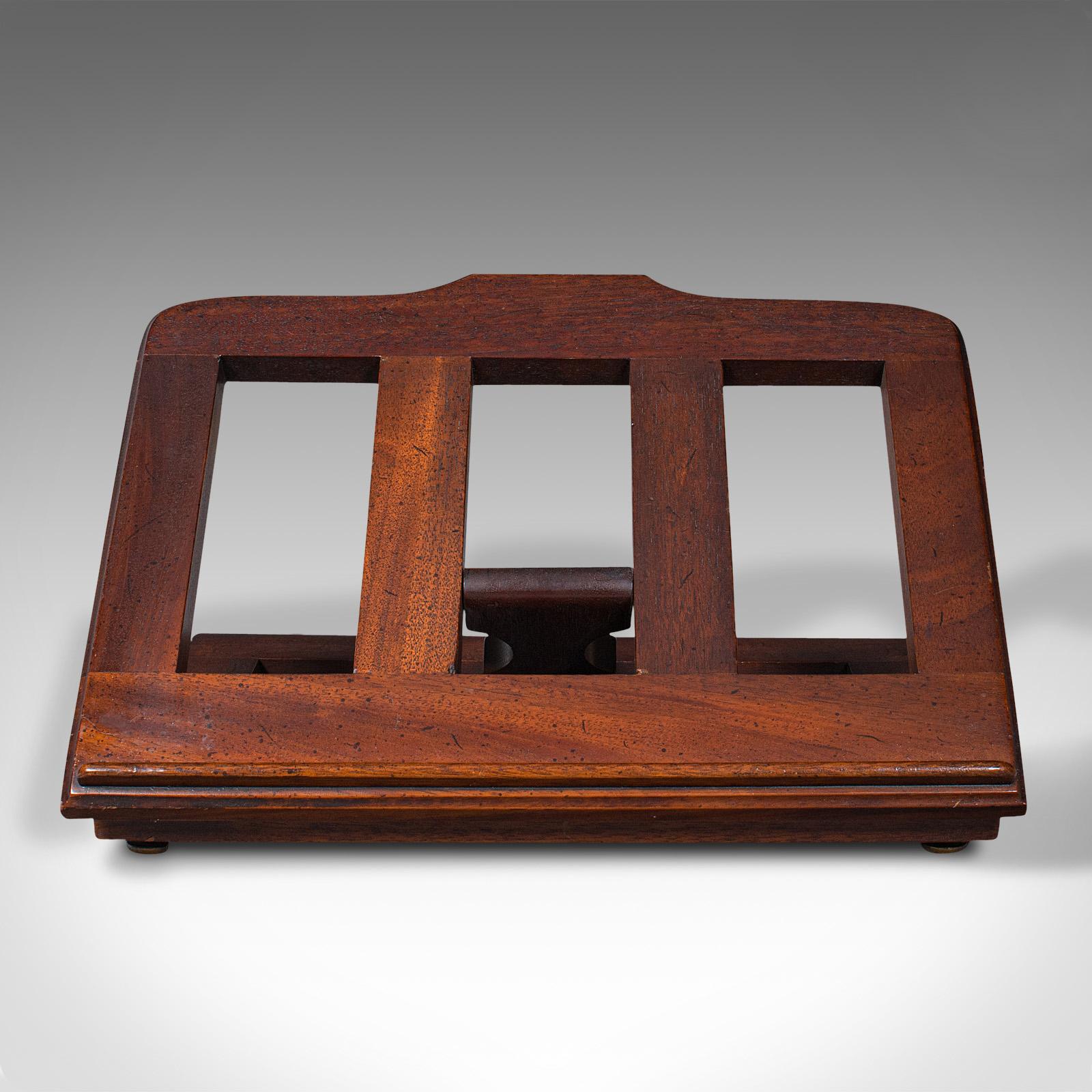This is an antique adjustable book rest. An English, mahogany sheet music or lectern rack, dating to the Victorian period, circa 1880.

Pleasing antique rest, ideal for public speaking or music recitals
Displays a desirable aged patina and in