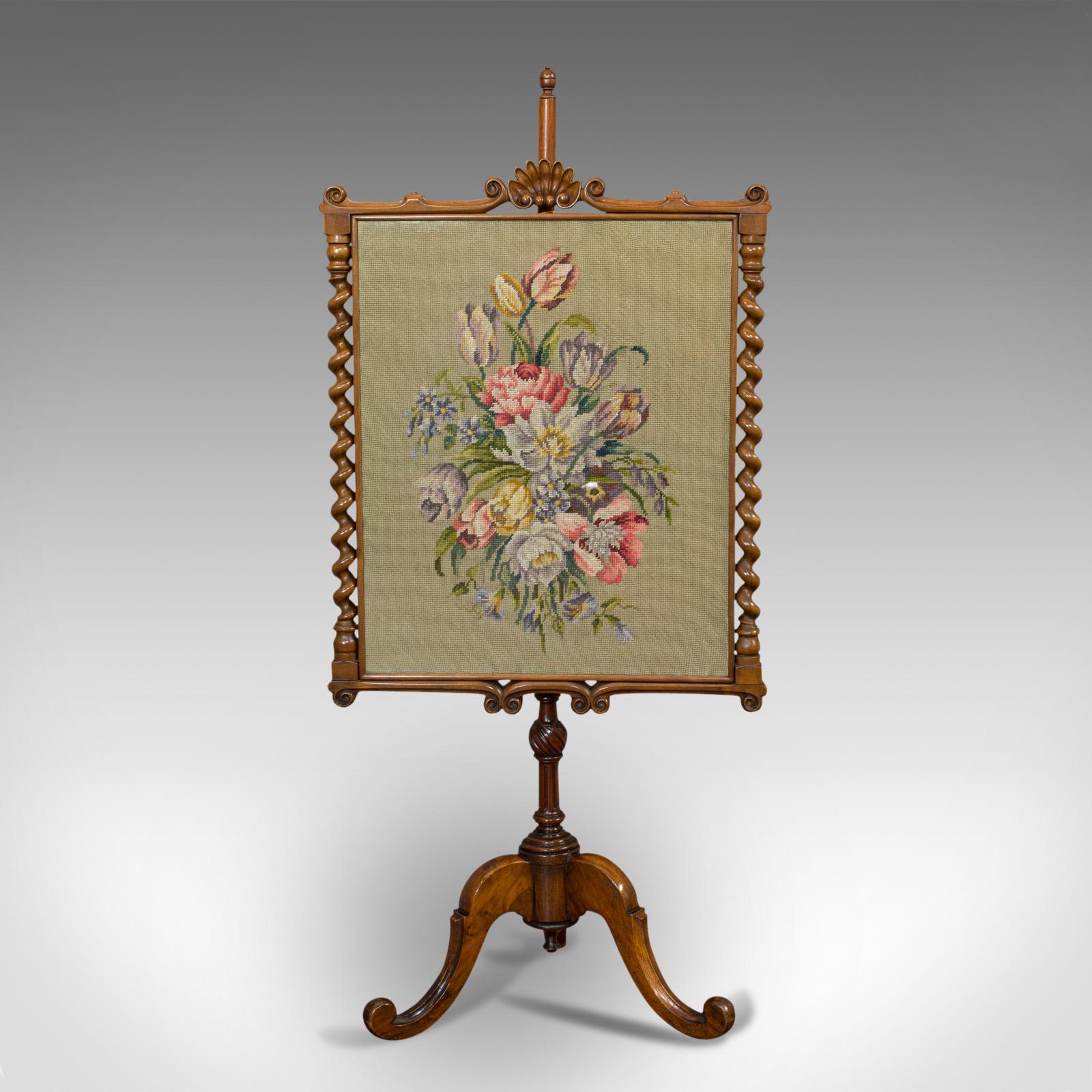 This is an antique adjustable fire screen. An English, walnut and needlepoint decorative pole screen, dating to the Regency period, circa 1820.

A screen with beautiful carved craftsmanship
Displaying a desirable aged patina
Rich walnut stocks