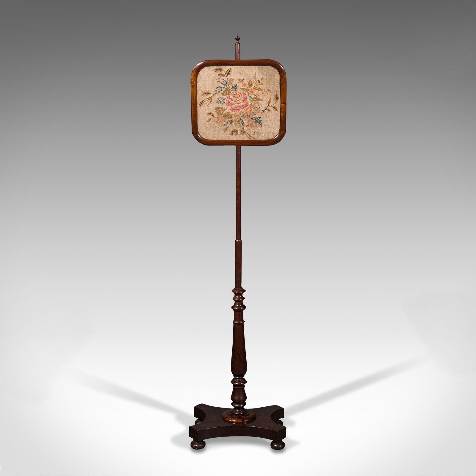 This is an antique adjustable pole screen. An English, Rosewood needlepoint fire shield, dating to the Regency period, circa 1830.

Quality Regency period fireside screen
Displays a desirable aged patina throughout
Select stocks show fine grain