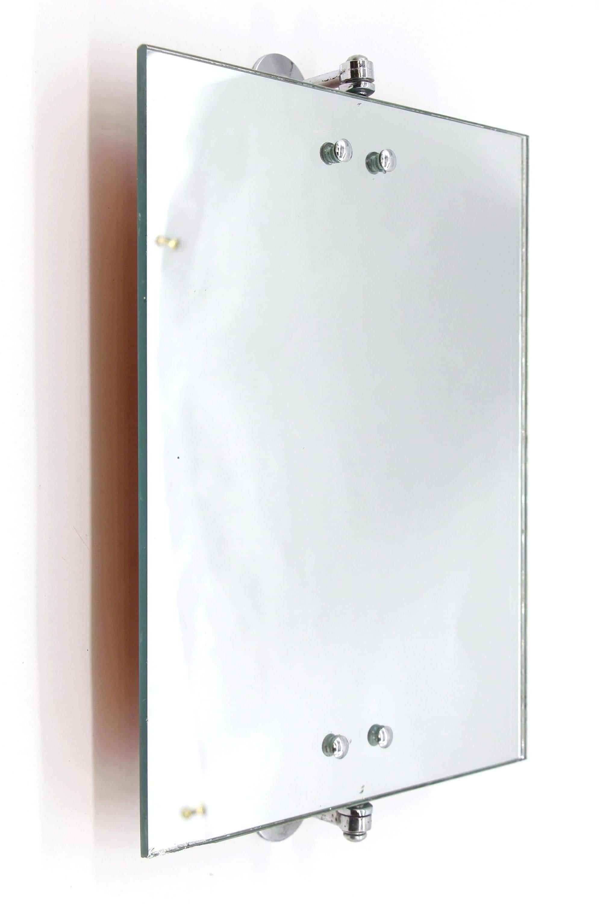 Mid-20th Century rectangular adjustable bathroom makeup mirror featuring brass nickel-plated hardware brackets. Adjustable.