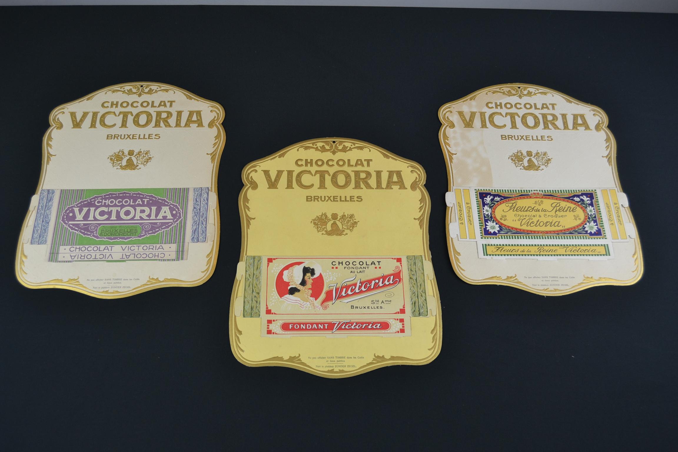 Antique advertising signs for Chocolate Victoria Brussels. These old advertising signs - advertising displays for Belgian Chocolate will be sold as a set of 3.

These displays are made of cardboard with gold lettering and details in relief on the