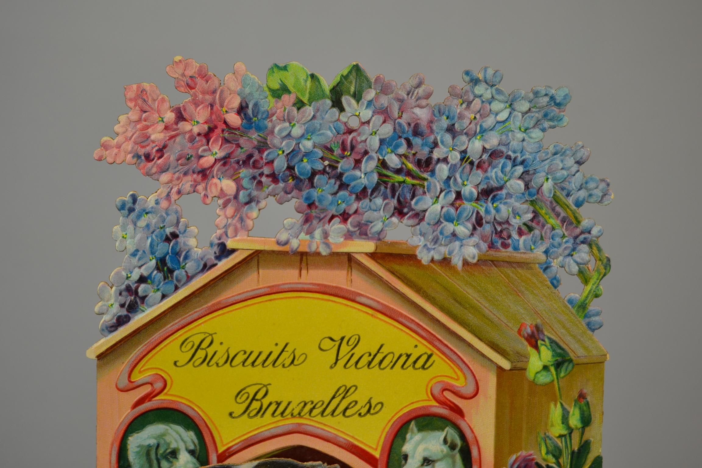 Antique Cardboard Publicity Sign - 3D Store Display in Relief Cardboard 
for Biscuits Victoria Brussels. This Sign dates 1920s and has the Suchard Biscuit and Chocolate Dog ! 

This Victoria Biscuit Wall Decoration Sign has elegant use of Pastel