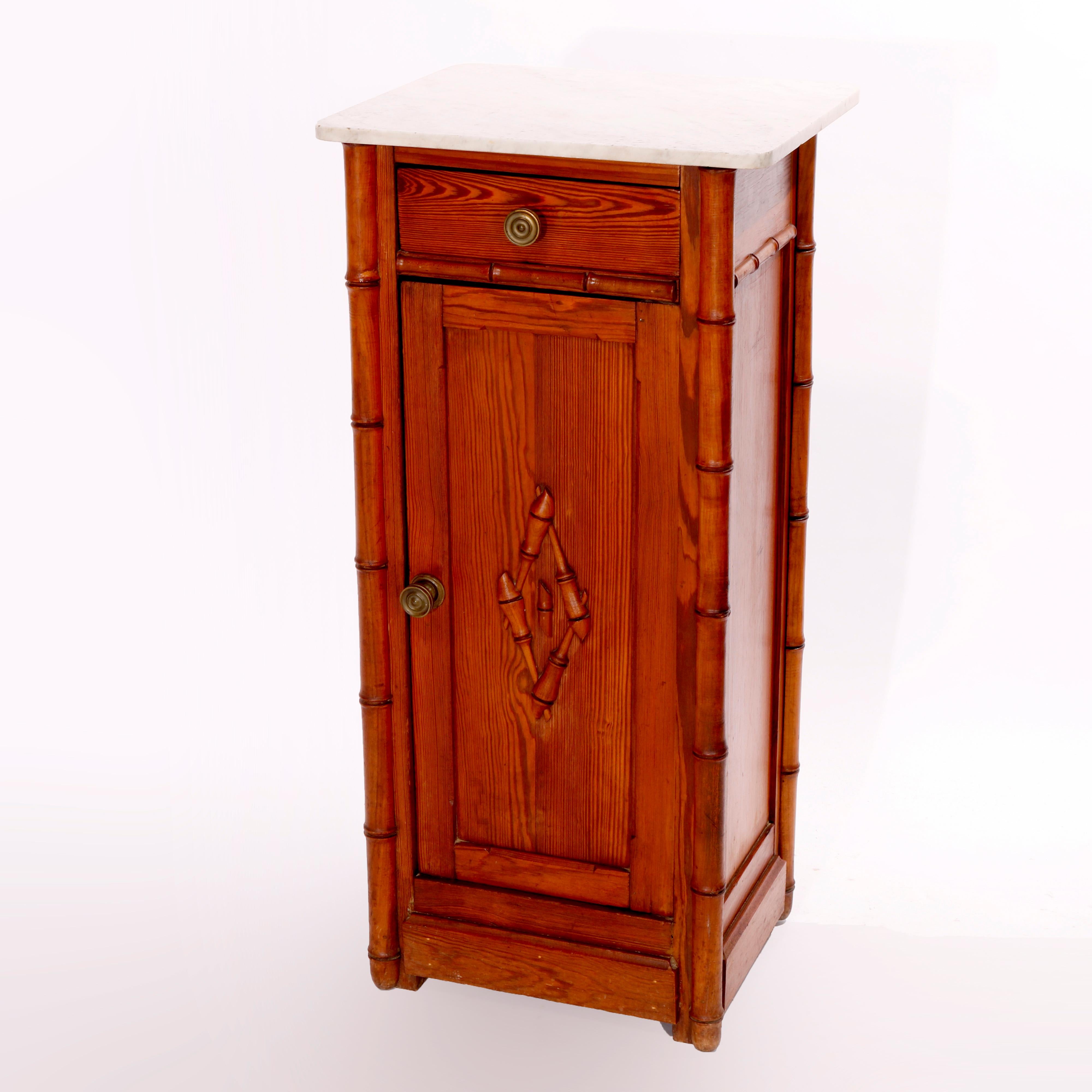 An antique Aesthetic side stand offers marble top over oak case having carved bamboo form corner supports and upper drawer over lower blind cabinet with door opening to shelved interior, c1890

Measures - 33'' H X 15.75'' W X 13.75'' D.

Catalogue