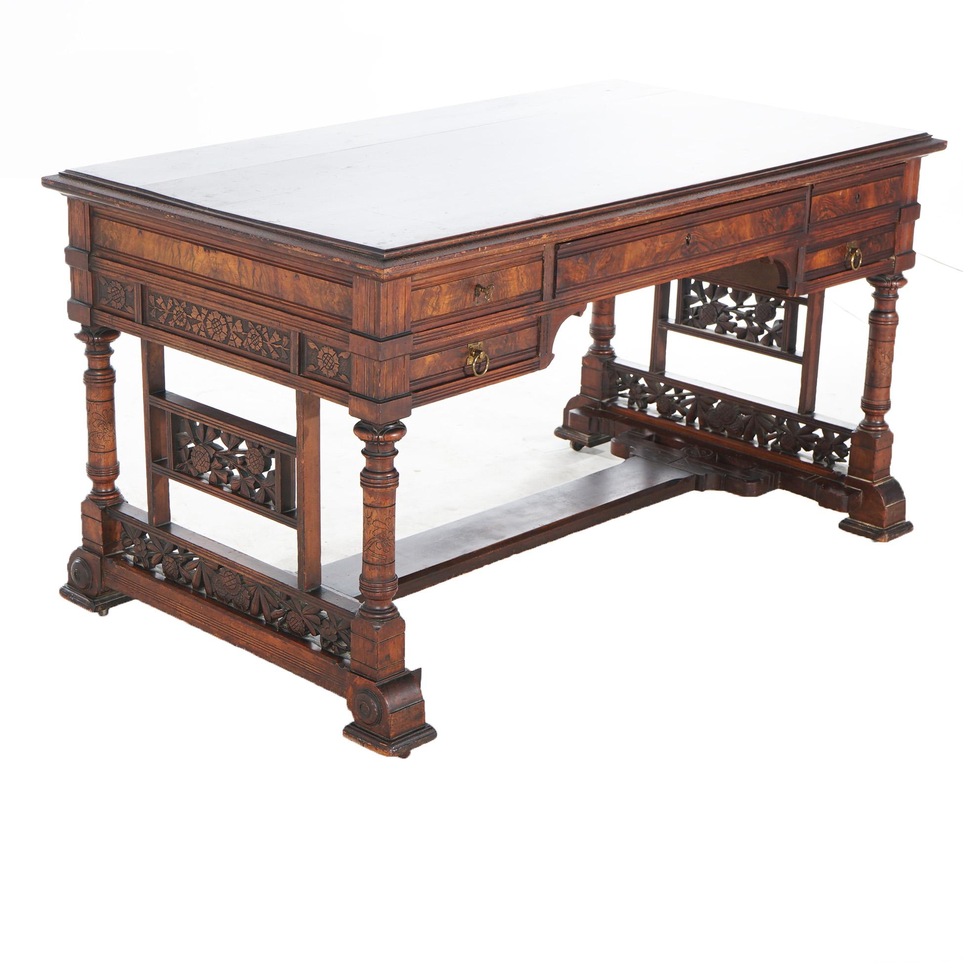 ***Ask About Reduced In-House Shipping Rates - Reliable Service & Fully Insured***
An antique Aesthetic Eastlake partners desk offers walnut construction with beveled top over case on trestle base having legs with foliate carved panels,