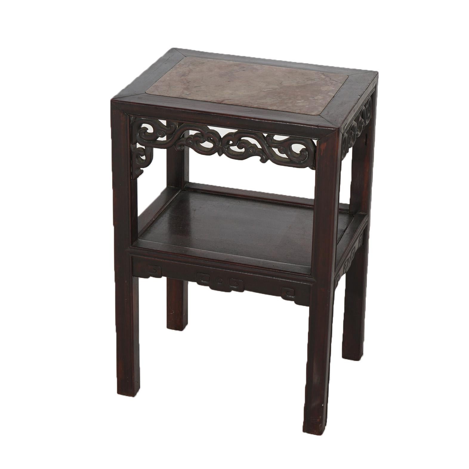 An antique Aesthetic side stand offers rosewood construction with and inset rouge marble top, foliate carved skirt, lower shelf and raised on straight square legs, c1910

Measures - 24.5