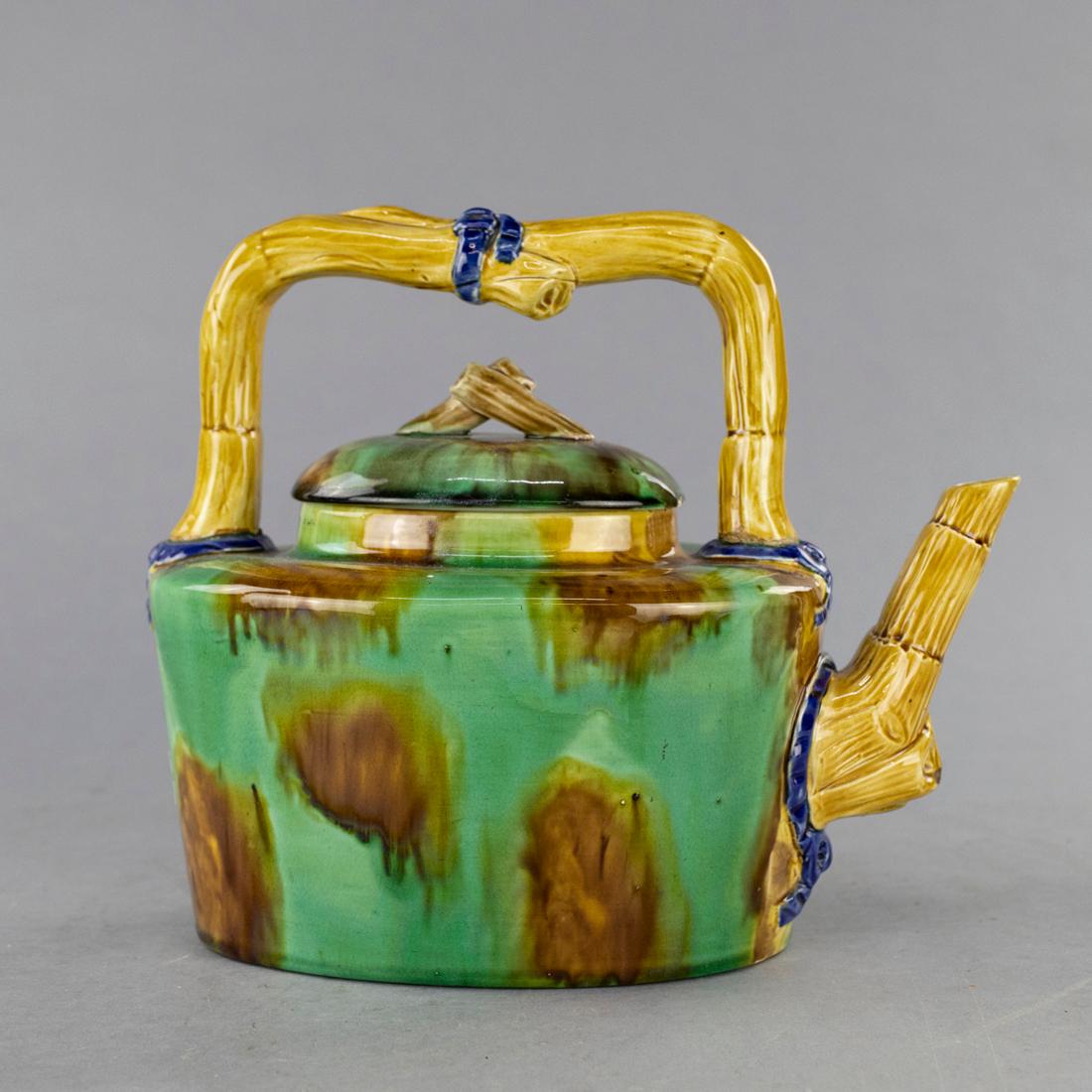An antique Japanese Aesthetic majolica pottery tea pot offers bamboo form handle and finial with drip glaze finish, marked on base illegible as photographed, c1910

Measures: 10