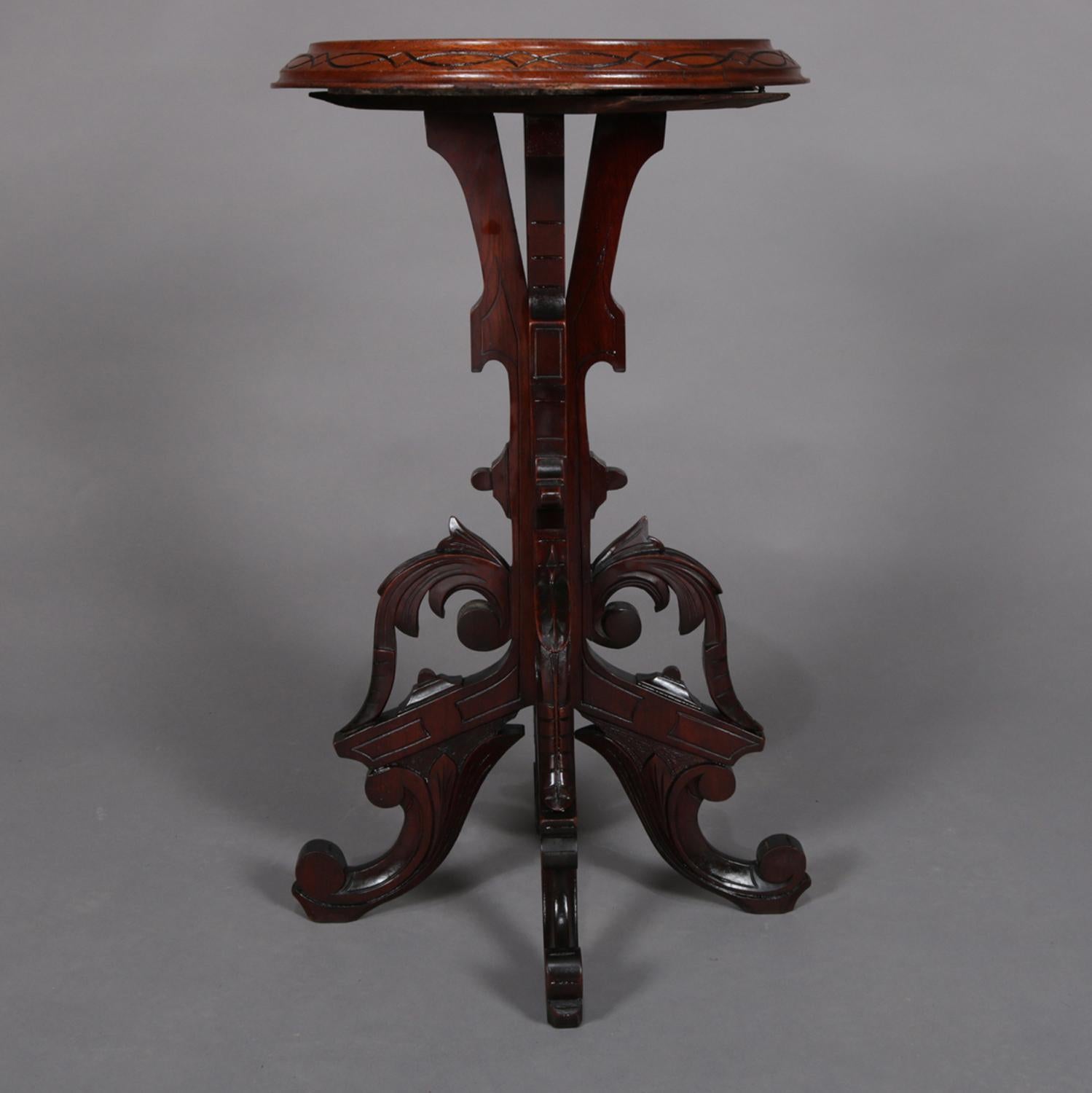 An antique Aesthetic Movement plant stand features marble top display having flared walnut frame with incised and ebonized repeating design surmounting carved acanthus and scroll form base, circa 1880

Measures: 29.5