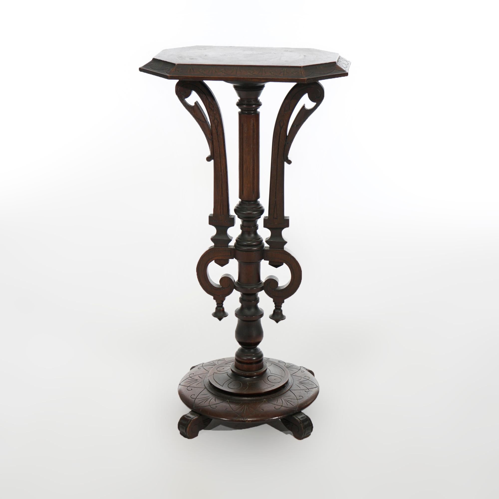 An antique Aesthetic Movement sculpture pedestal offers walnut construction with beveled rectangular display over turned column having flanking scroll elements raised on bae with stylized scroll feet, c1890

Measures- 34''H x 18''W x