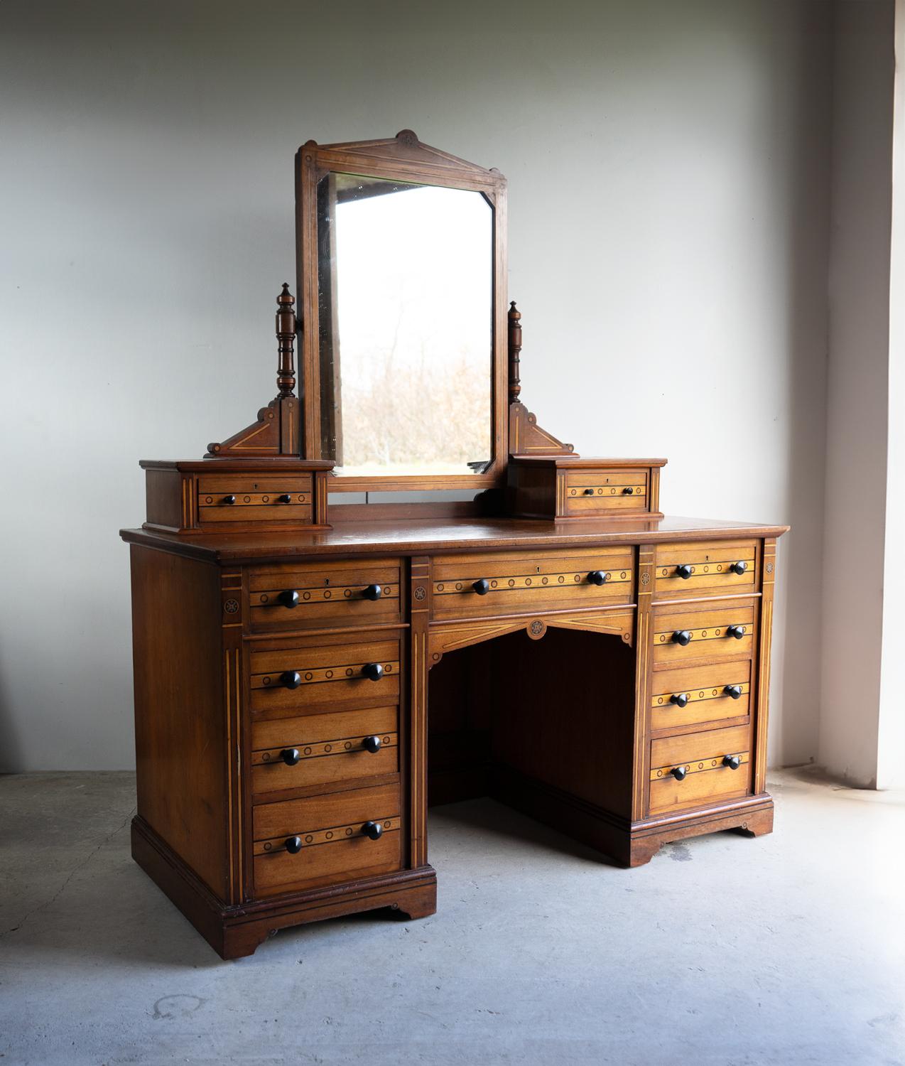 ANTIQUE DRESSING TABLE

A decorative and good-quality country house dressing table on a larger-than-average scale.

A practical configuration with eleven drawers of differing sizes surrounding a central kneehole section and a large tilting dressing