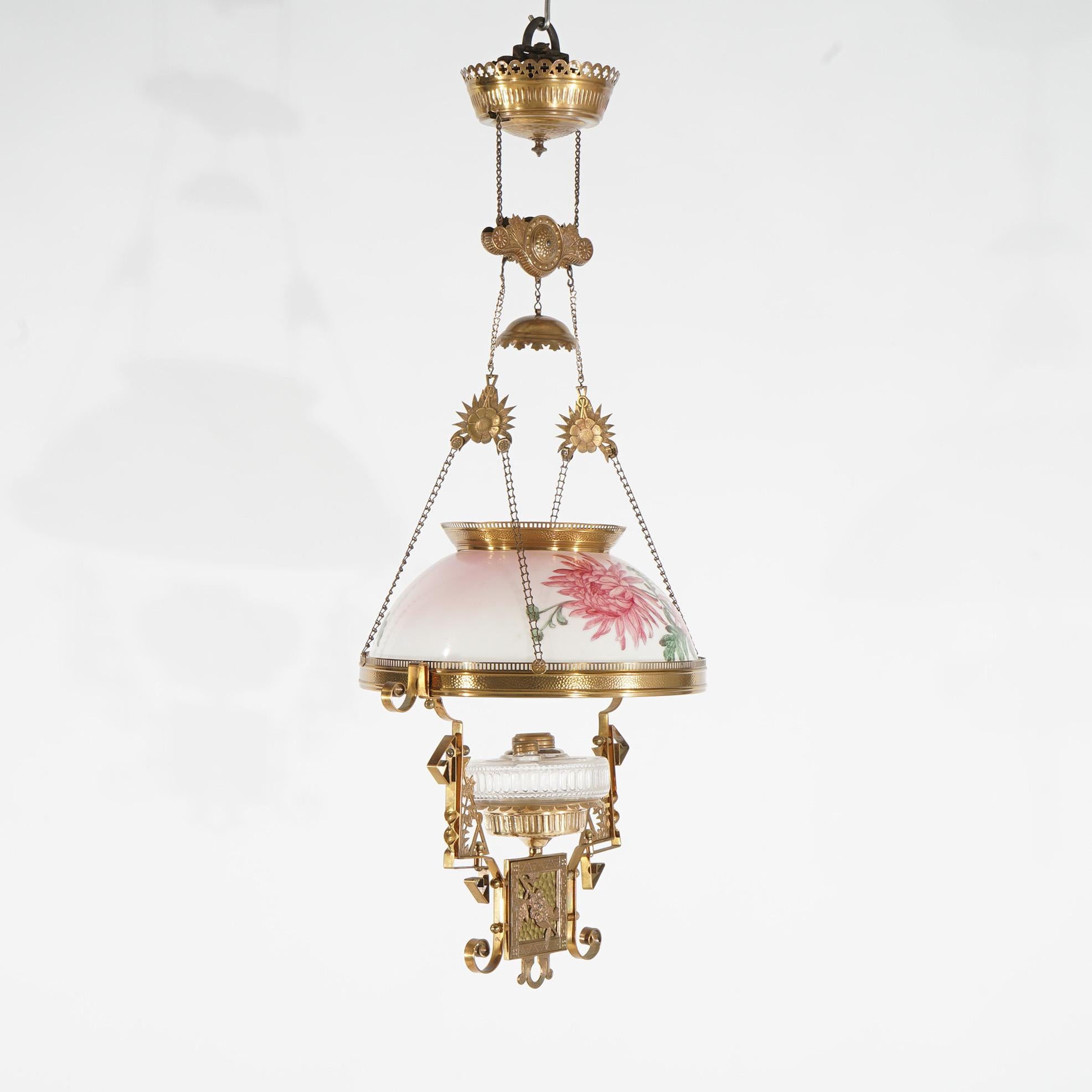 An antique Aesthetic Movement hanging kerosene lamp offers brass scroll form frame with floral hand painted glass shade & font c1890

Measure - 39
