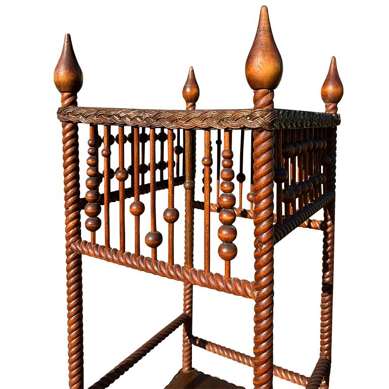 An exquisite 19th-century spool-turned side table featuring remarkable hand-carved rope detailing and sculptural finials. Likely originating from England or the American East Coast circa 1890, this piece embodies the Aesthetic Movement’s love for