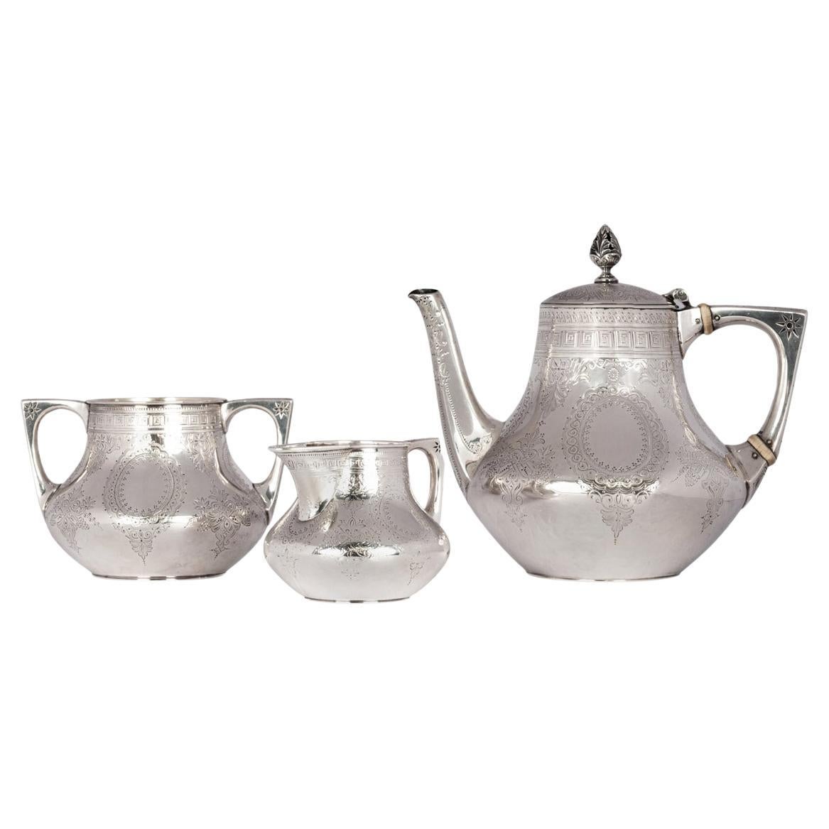 A fine antique sterling silver Aesthetic Movement tea service, by Walter & John Barnard, London 1878.
This very fine antique sterling silver set comprises three pieces, tea or coffee pot, sugar bowl and cream jug. The set is decorated in the