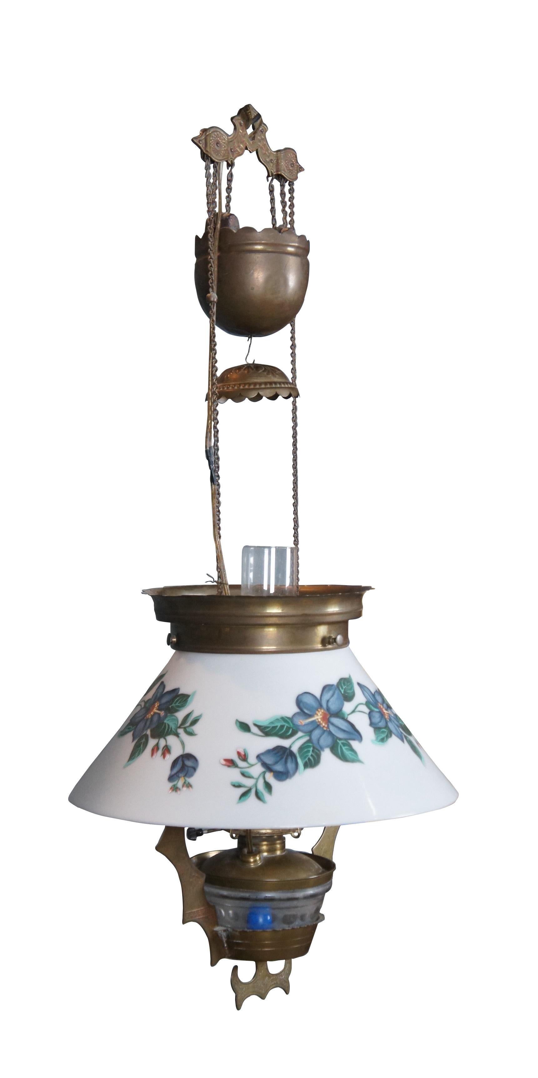 Late 19th century circa 1882 Victorian / Aesthetic period converted hurricane oil lamp swag pendant light / chandelier. Brass frame with etched cranes on the batwing style side supports. Glass oil reservoir (illuminates with main light); milk glass