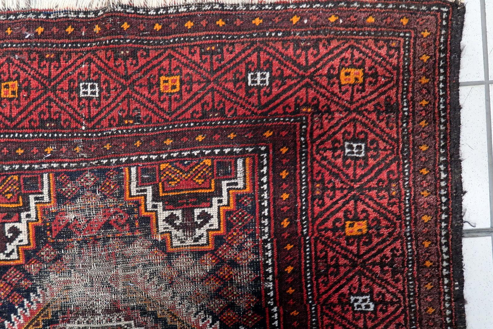 A remarkable antique Afghan Baluch rug from the 1920s, exemplifying the bold geometric artistry and rich color palette characteristic of Baluch tribal weaving. This hand-knotted wool runner features a dramatic composition of four large diamond