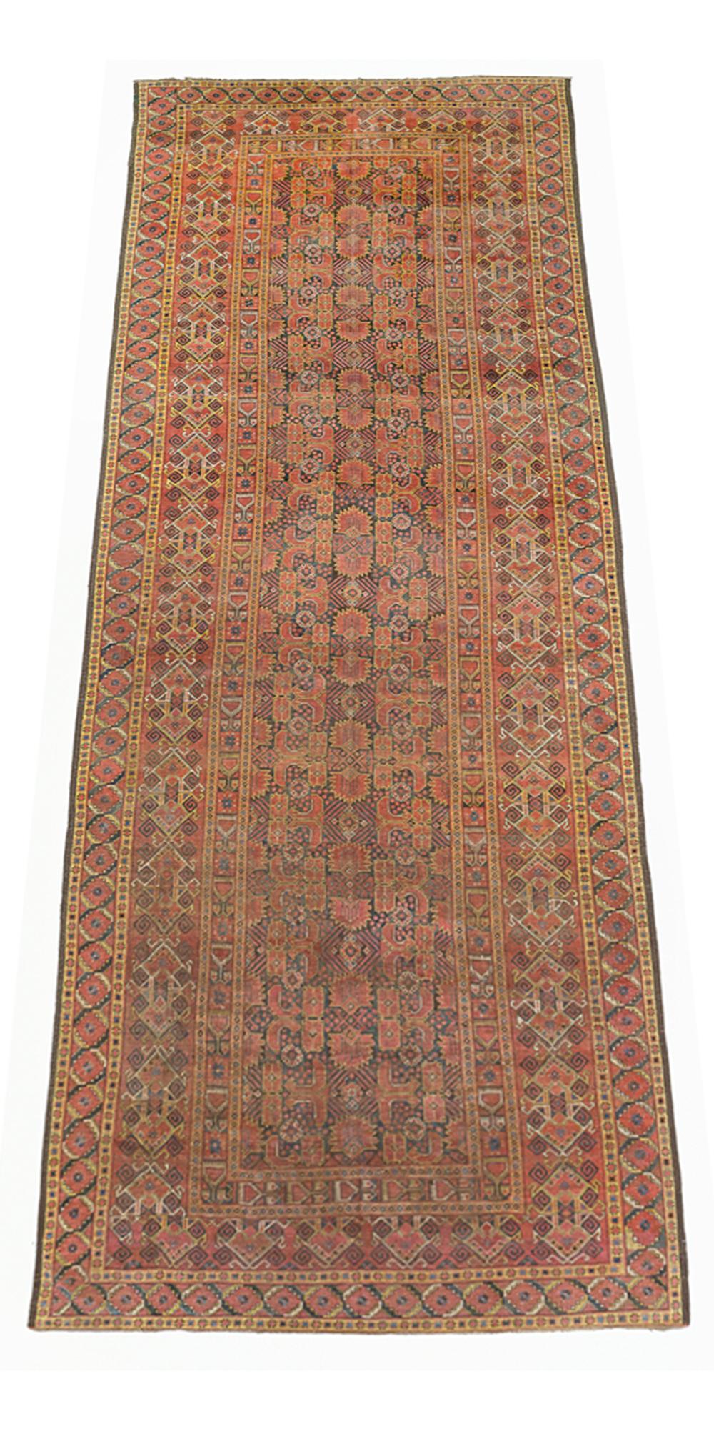 Antique Afghan rug handwoven from the finest sheep’s wool and colored with all-natural vegetable dyes that are safe for humans and pets. It’s a traditional Bashir design featuring a lovely reddish brown field covered with black and yellow mixed