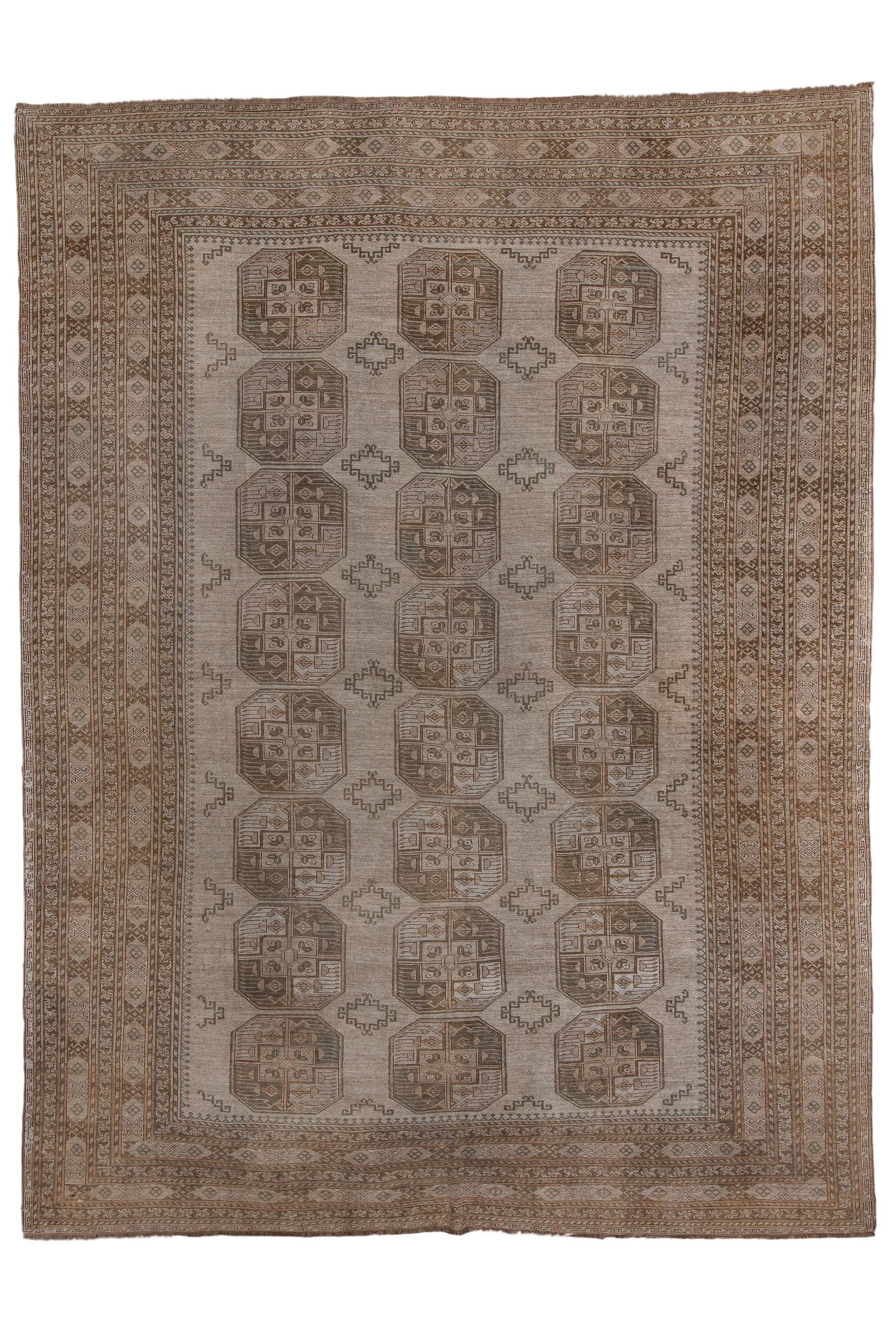 This wool foundation, moderately/coarse knotted Turkmen tribal piece shows three columns of  eight octagonal, quartered guls each, all on a tan ground, with stepped lozenge minor guls between. Main borders with  X and cartouche patterns, three