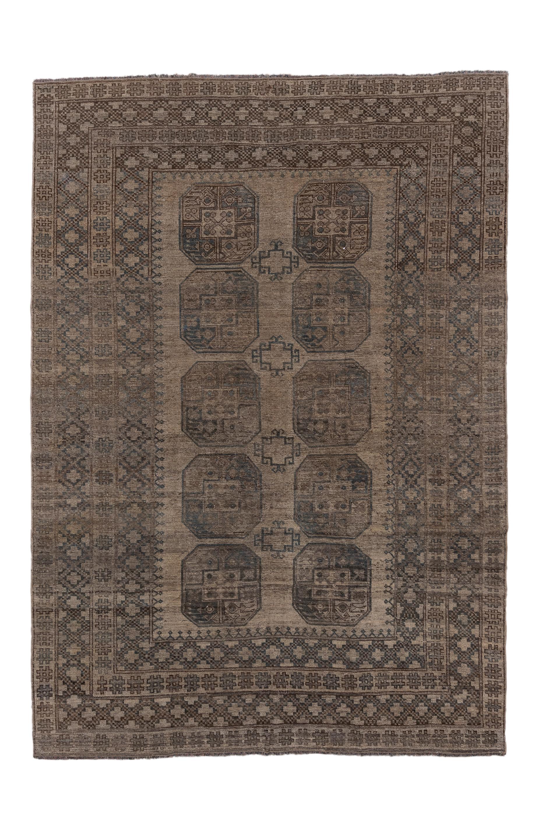 This all wool tribal piece shows a tan field with two columns each of five characteristic emblematic octagonal Gulli guls with small stepped cruciform minors between.  The very wide and  multifarious border system show two bands of connected