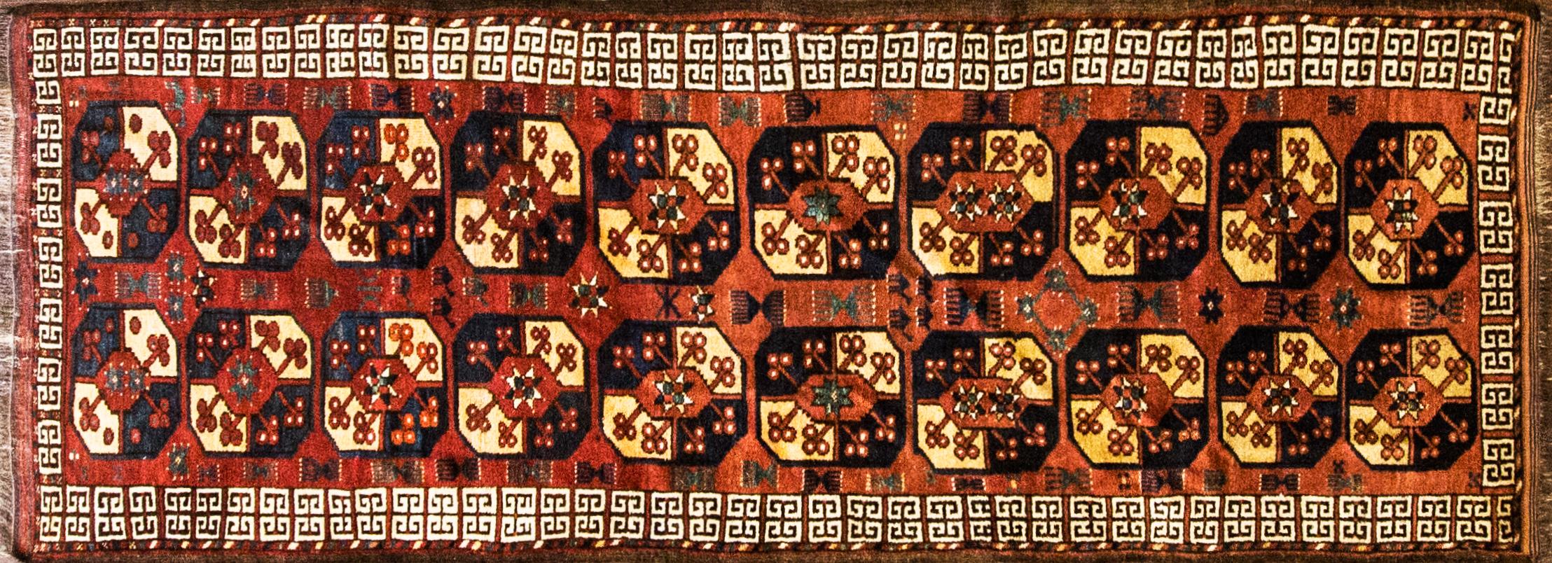 This runner has a rich color's field that displays two columns of characteristic octagonal Ersari tribal guls quartered in gold green and blue. There is a abrashes lighter in the red. A very attractive Central Asian Turkmen carpet in quite good