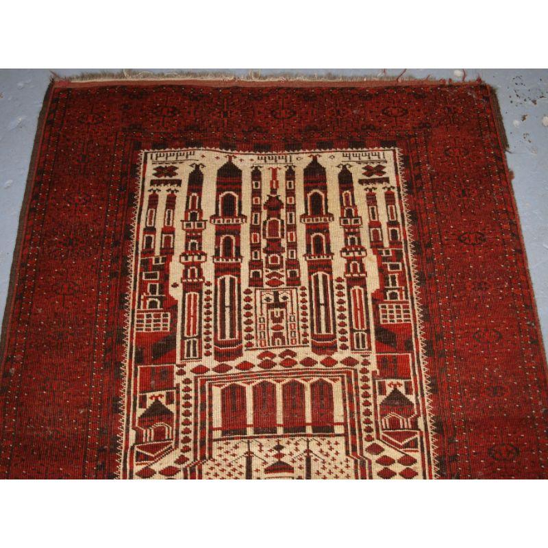 Antique Afghan prayer rug of traditional village mosque design by the Kizil Ayak Turkmen.

The rug is of typical mosque design showing a mosque at the top and the field depicting the inside of a mosque. This group of prayer rugs depict a mosque