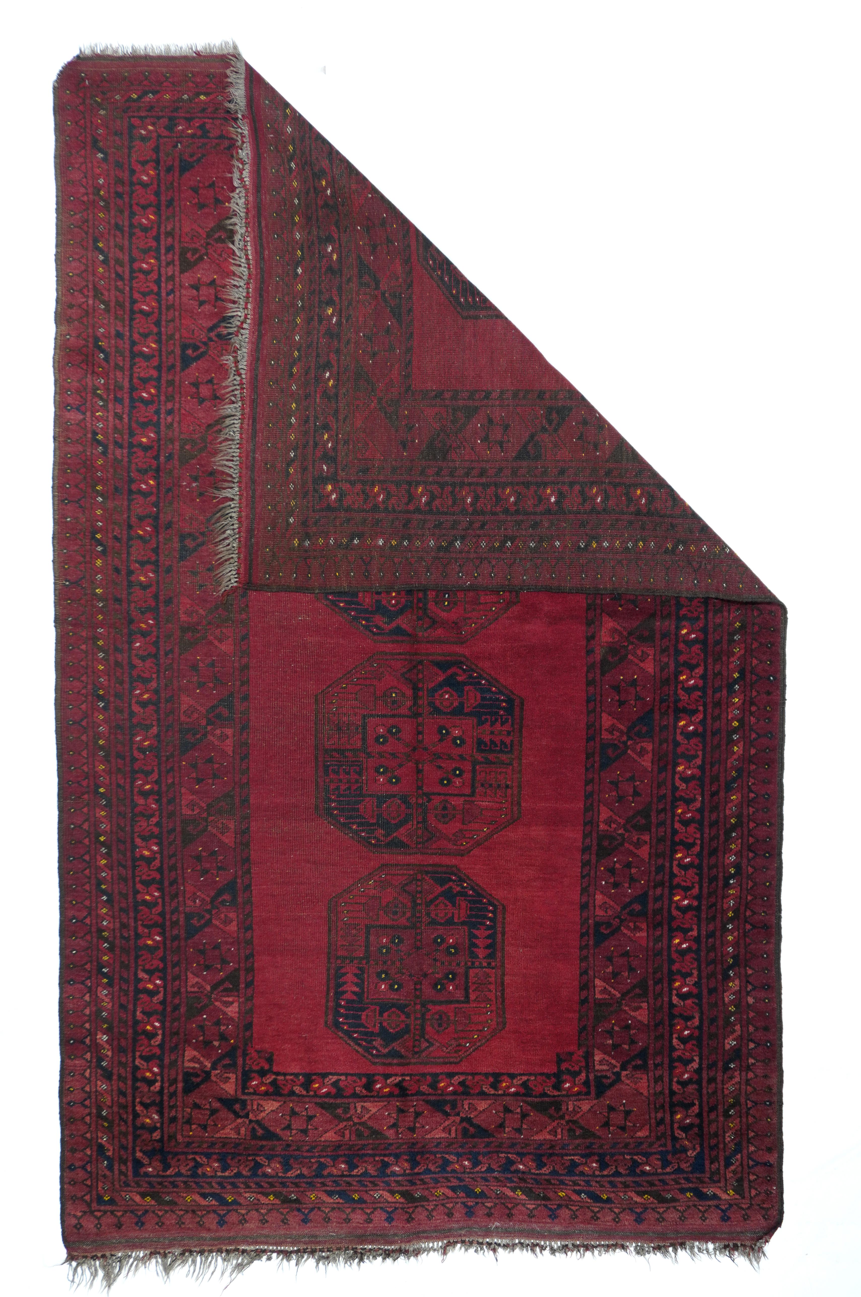 Antique Afghan rug 5' x 8'2''. The red ground of this nomadic scatter is decorated only by four octagonal Turkmen guls quartered in black and red. Saryk style hexagon/star and X main border. Outermost triangle turret border. All wool construction,