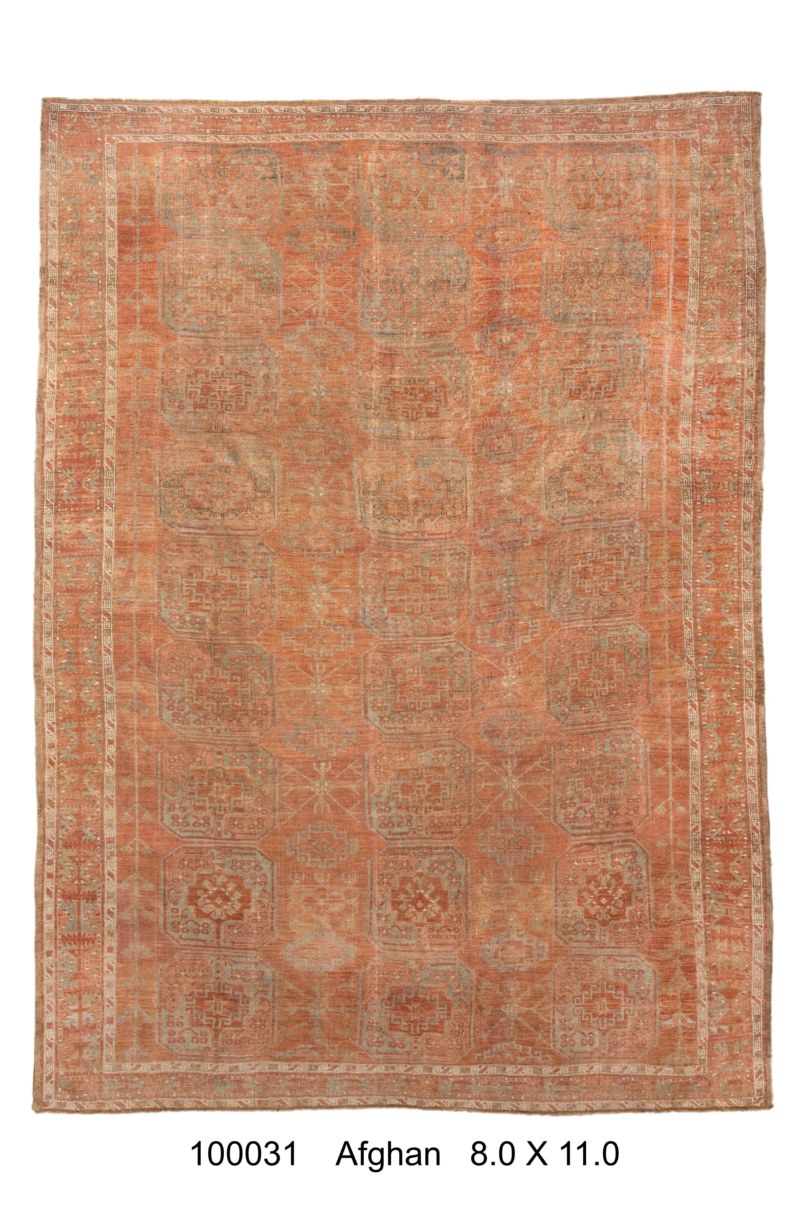 This antique Afghan rug features a classic repeating 