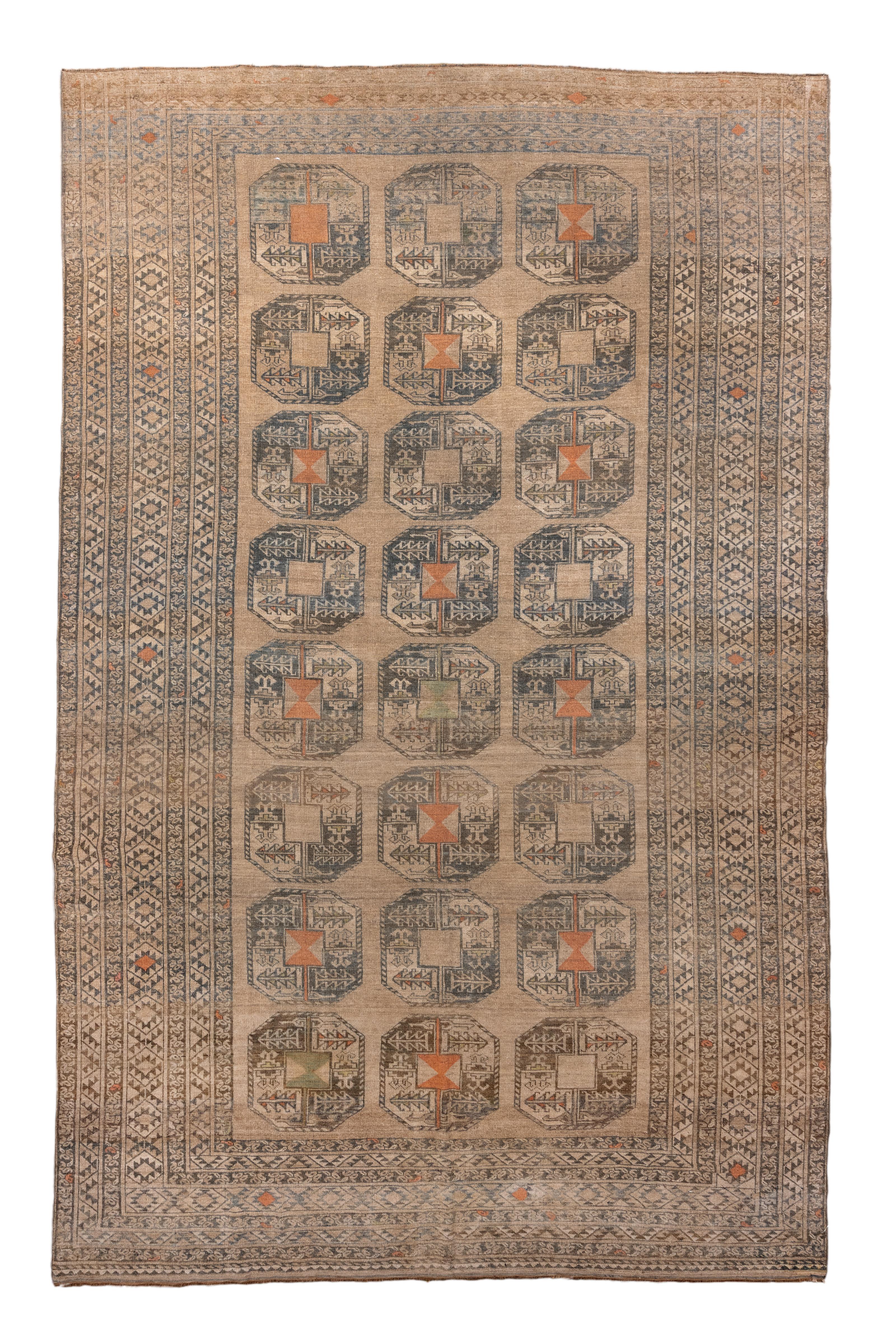 A grand and commanding antique Afghan rug, this hand-knotted piece features a repeating 