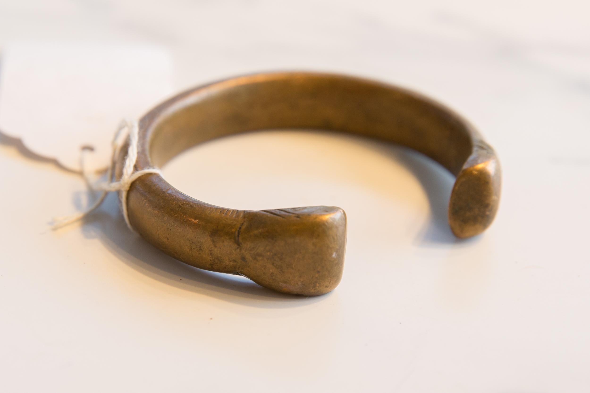 :: Antique handmade African bronze snake cuff bracelet. Exceptional antique circa early 19th century or older bracelet. Thought to be worn in order to protect the wearer from snake bites, though possibly used for currency as well. This piece is