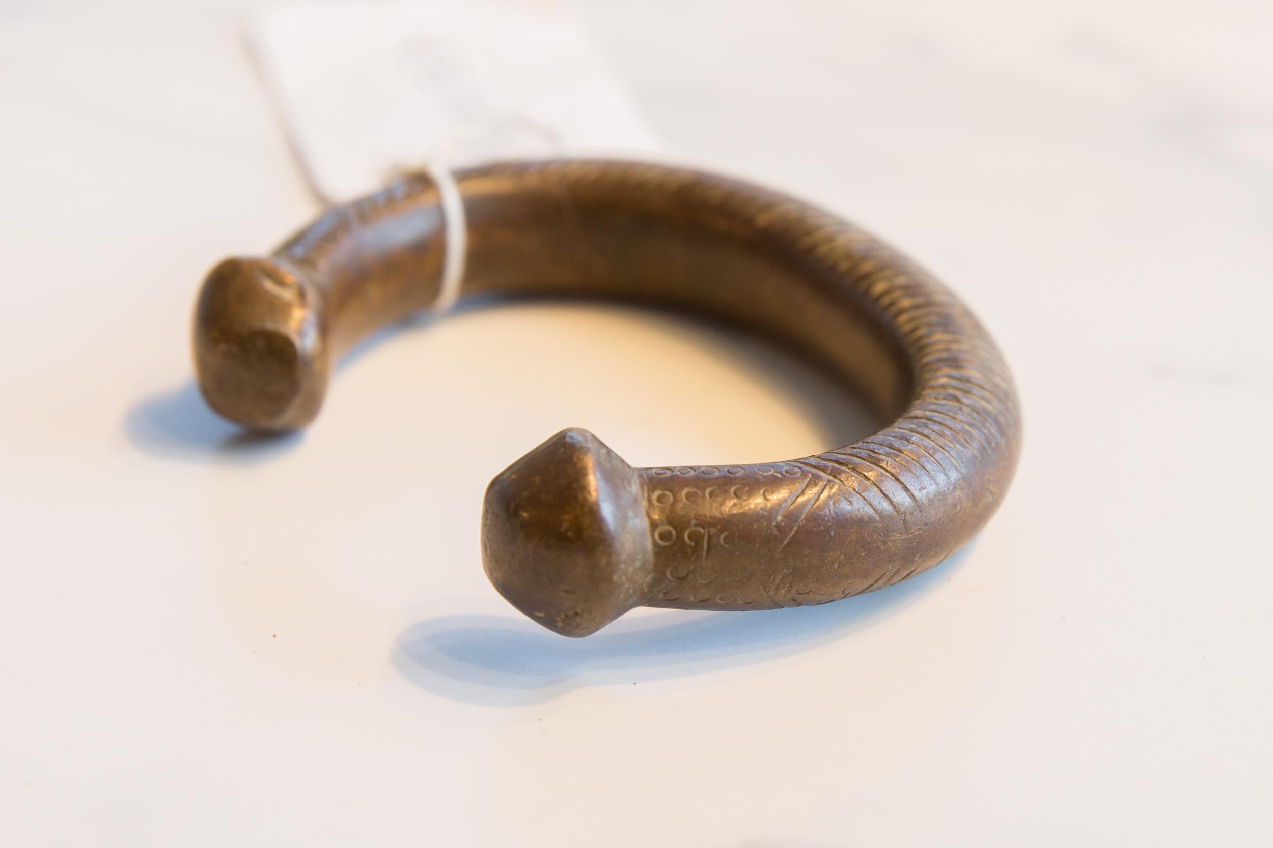:: Antique handmade African bronze snake cuff bracelet. Exceptional antique circa early 19th century or older bracelet. Thought to be worn in order to protect the wearer from snake bites, though possibly used for currency as well. This piece is