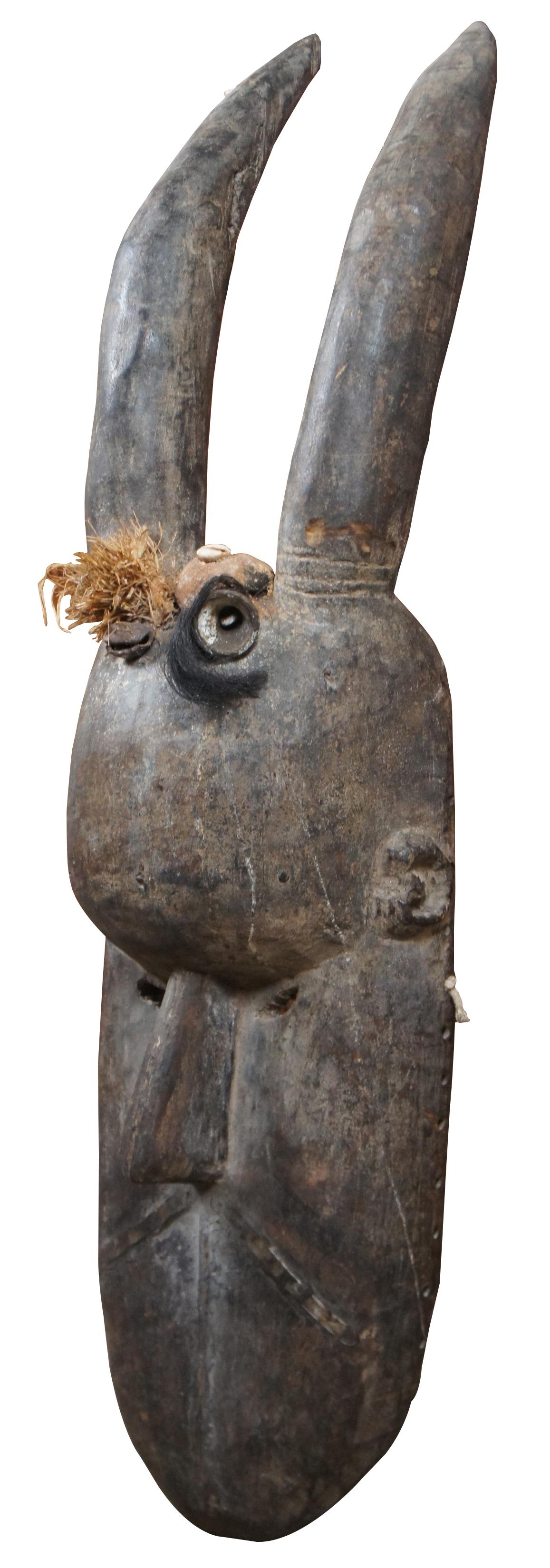 Early antique hand carved Toma or Landai mask from Guinea, Africa. “These brooding, often quite large, masks represent a forest spirit, Landai. Masks like these were used by the men's Poro Society to initiate boys into manhood. The masks, in what