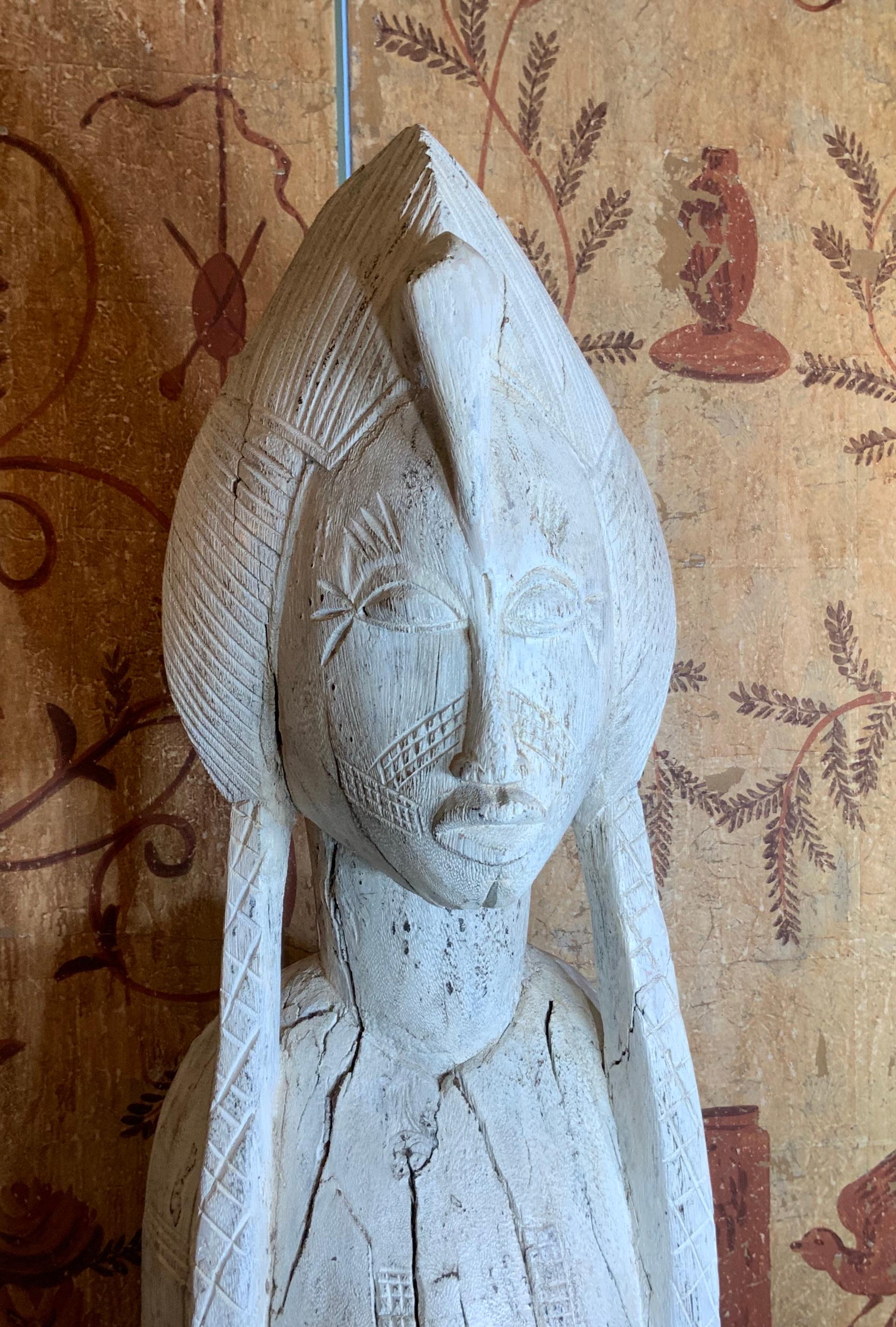 Exceptional hand wood carving of a woman probably African queen, beautiful face showing grace and resolute looking forward, white color finish and clear wax restoration. Professionally mounted on solid wood base. Would make powerful object of art