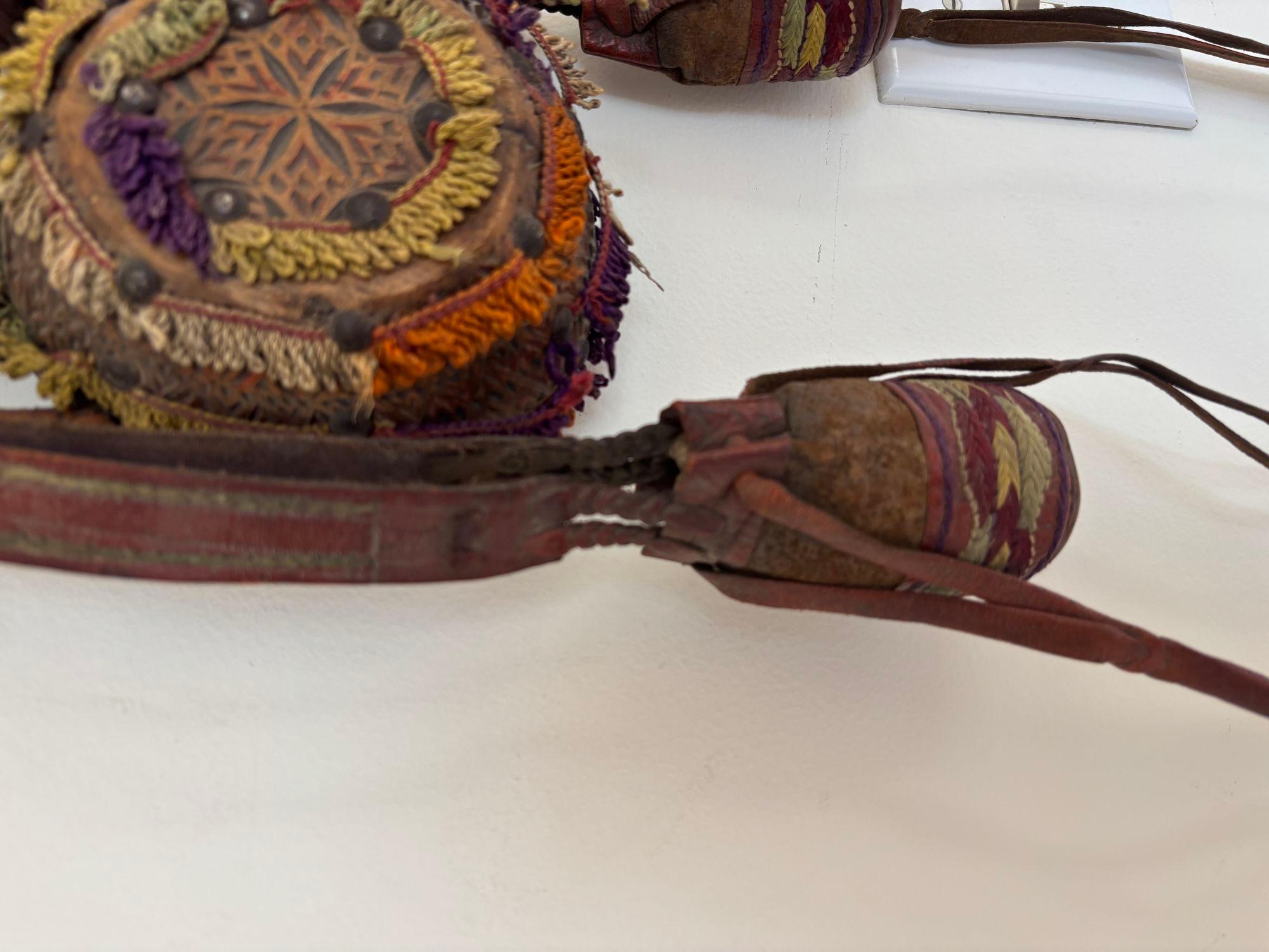 Antique North African Moroccan Tuareg wood medicinal flask.
Rare late 19th century medicinal flask box from The Tuareg in South Morocco with a drum-shaped body hand carved wood with ethnic motifs, brass studded nails,leather and wool with nice