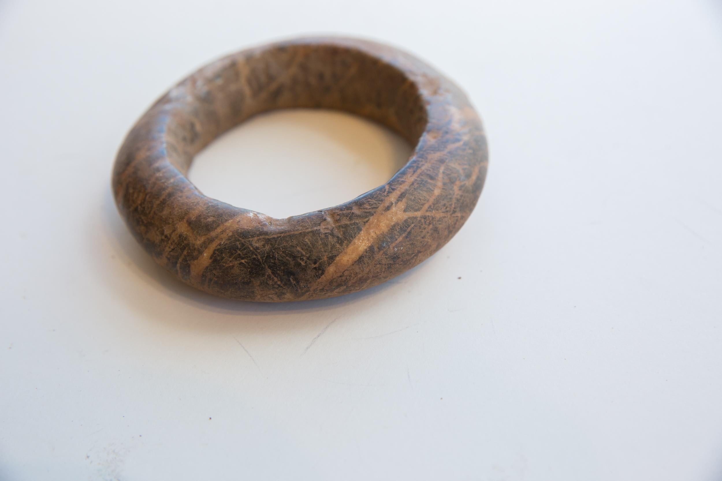 :: Antikes handgefertigtes afrikanisches Marmorarmband aus dem Neolithikum. Diese Marmorarmbänder wurden in Nordafrika handgeschnitzt und wahrscheinlich als Zahlungsmittel verwendet. Dieses Stück ist ein einzigartiges Sammlerstück, das mit großer