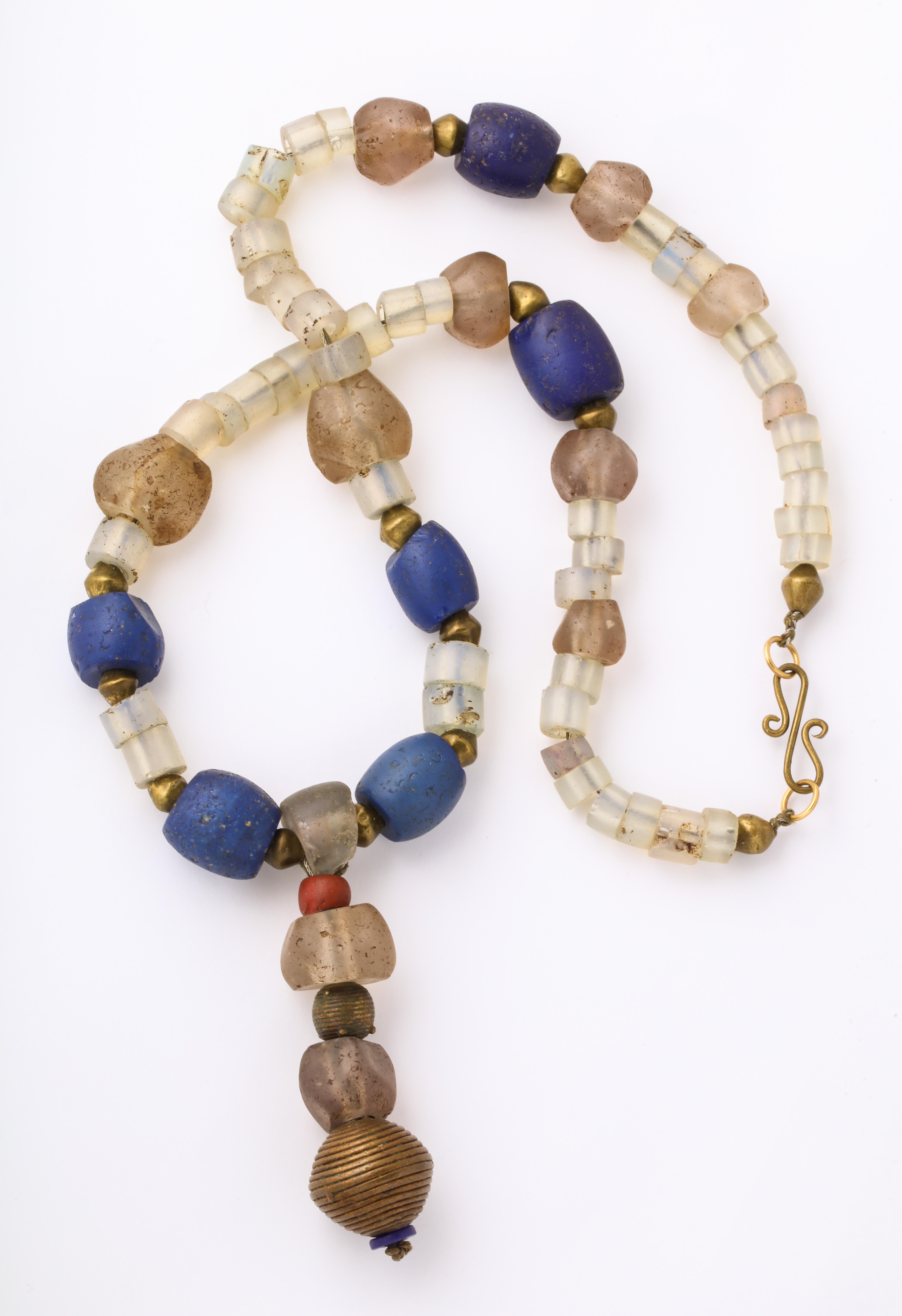 A fabulous story out of Africa, this lovely antique necklace is composed of various beads from the Ashanti Tribe in Ghana from the 19th century, Blue glass beads from the Nigeria, Opaque blue glass beads from Dogon Tribe centuries old and brass from