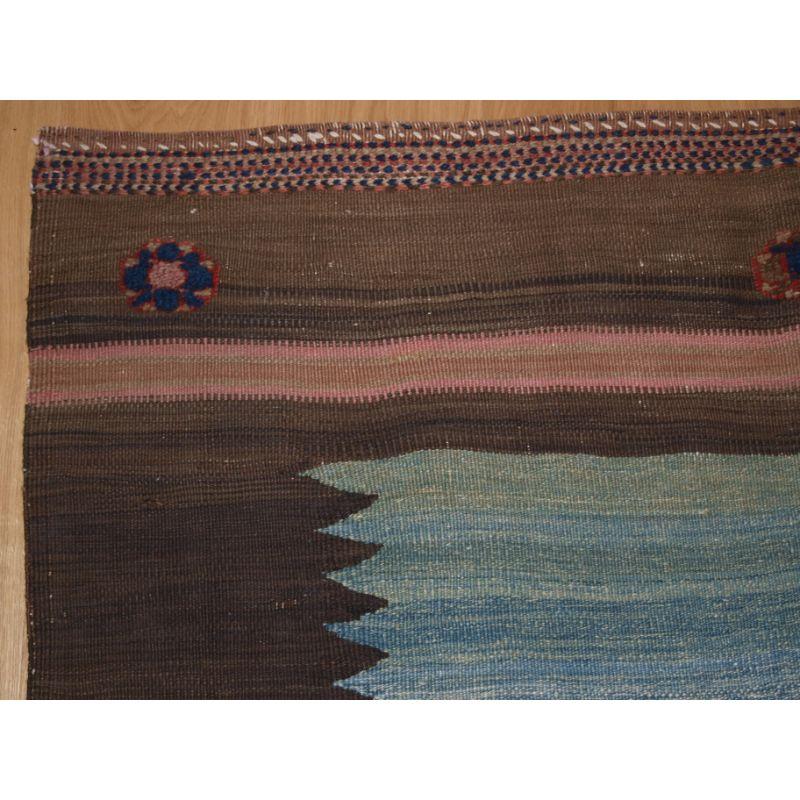 A good sofreh (eating cloth) by the Afshar tribe; these were placed on the ground for food to be served on or in some cases for the preparation of bread.

This Sofreh combines woven and plain flat weaves with elegant piled rosette designs. The