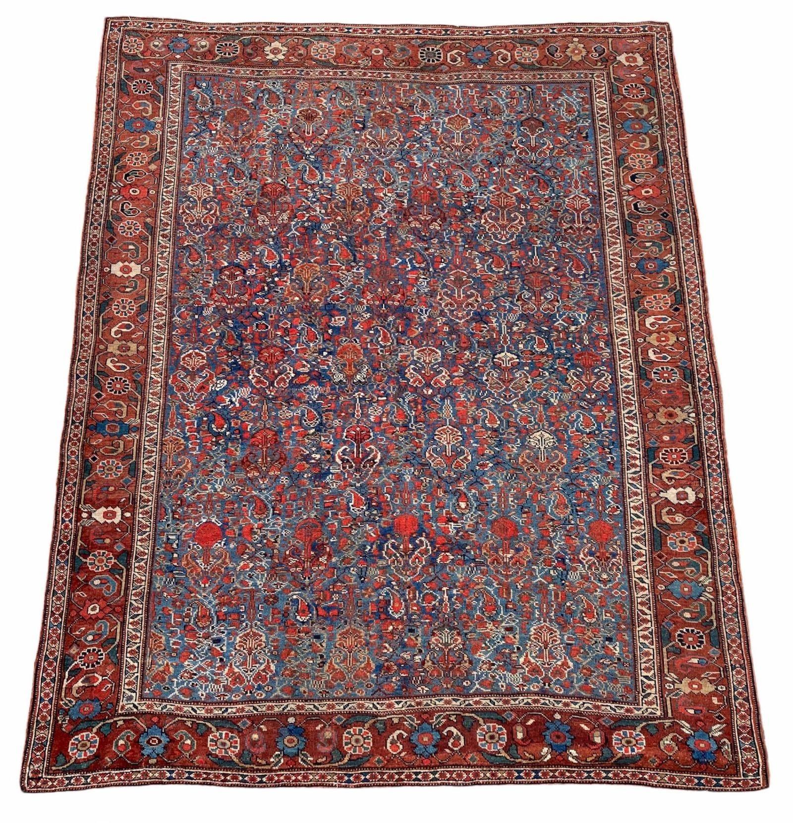 A fabulous antique Afshar rug, handwoven circa 1900 with an unusual all-over design of linked flowers and leaves on a mid blue field and great secondary colours. Finely woven for a tribal rug and lovely soft handle. 
Size: 1.70m x 1.42m (5ft 7in x