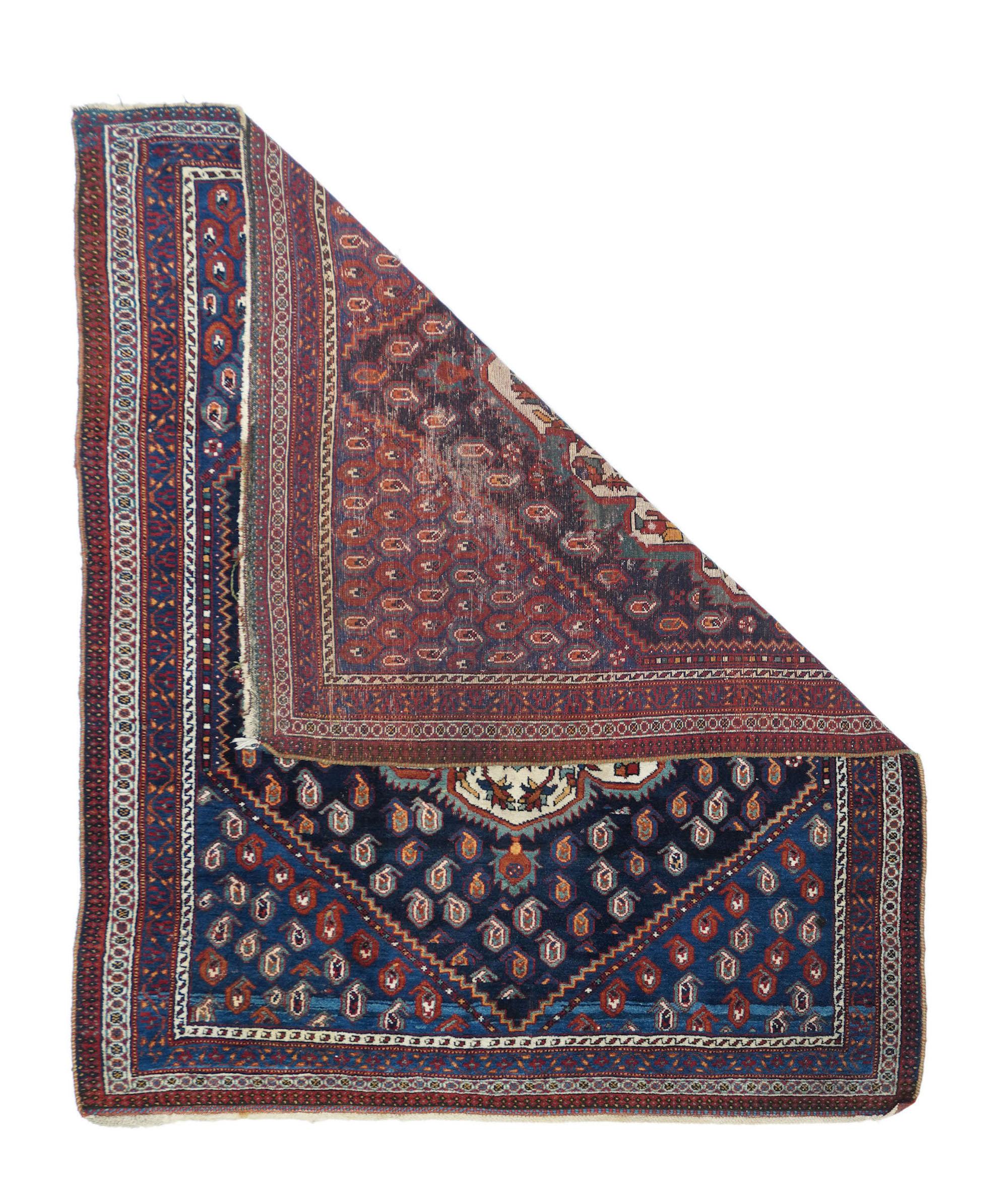 Antique Afshar rug. Measures: 3.11'' x 4.10''. Rows of small reversing botehs fill the navy subfield and the surrounding medium blue field, while in the centre is a large 12 lobe ivory medallion with ragged barbed edge and a red octogramme
