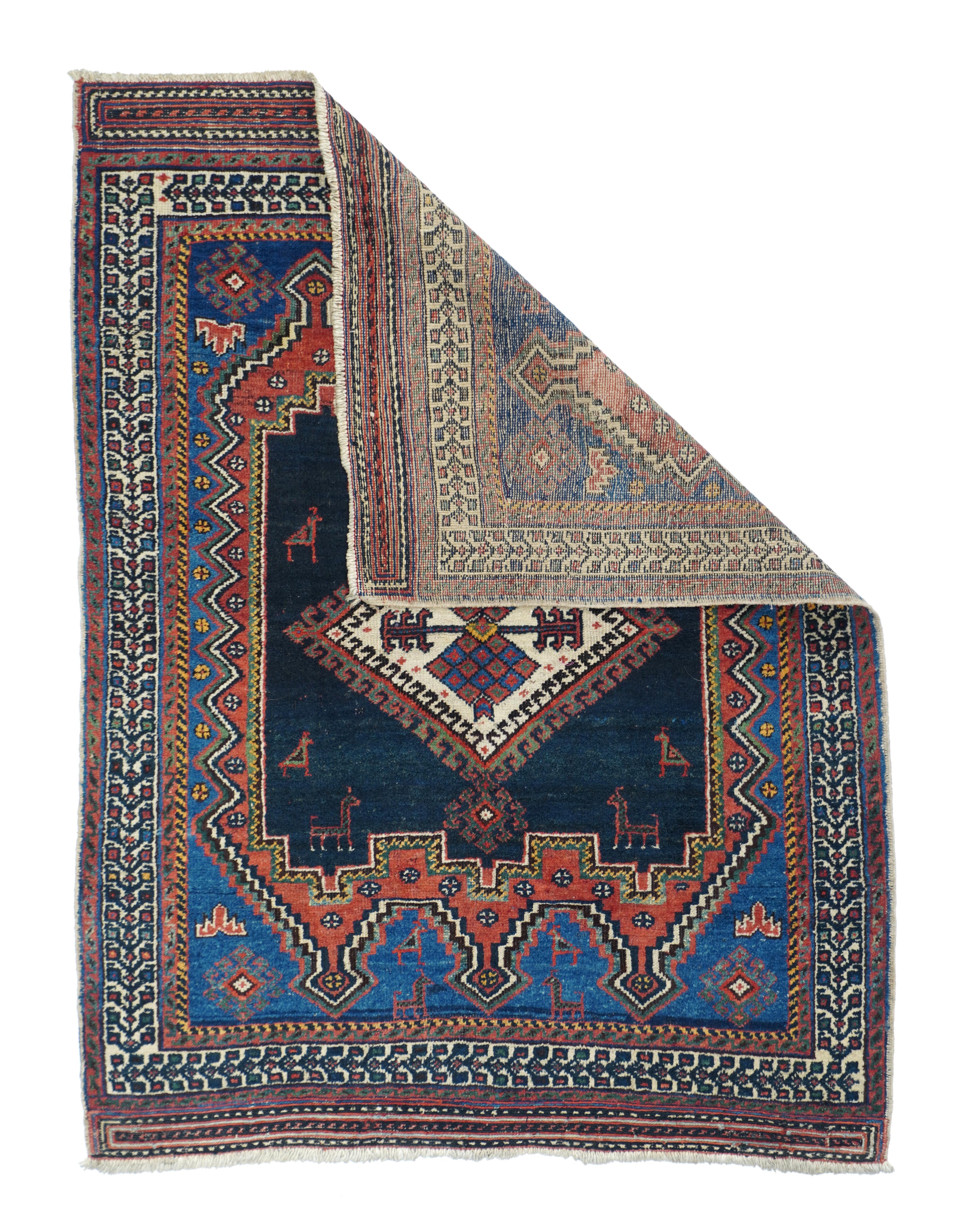 One of our many collectible SE Persian tribal Afshar rugs, this example features a cerulean blue field, centring a coral cartouche subfield with six finial points, and further enclosing a conforming navy panel with a hooked, lozenge focused. Animals