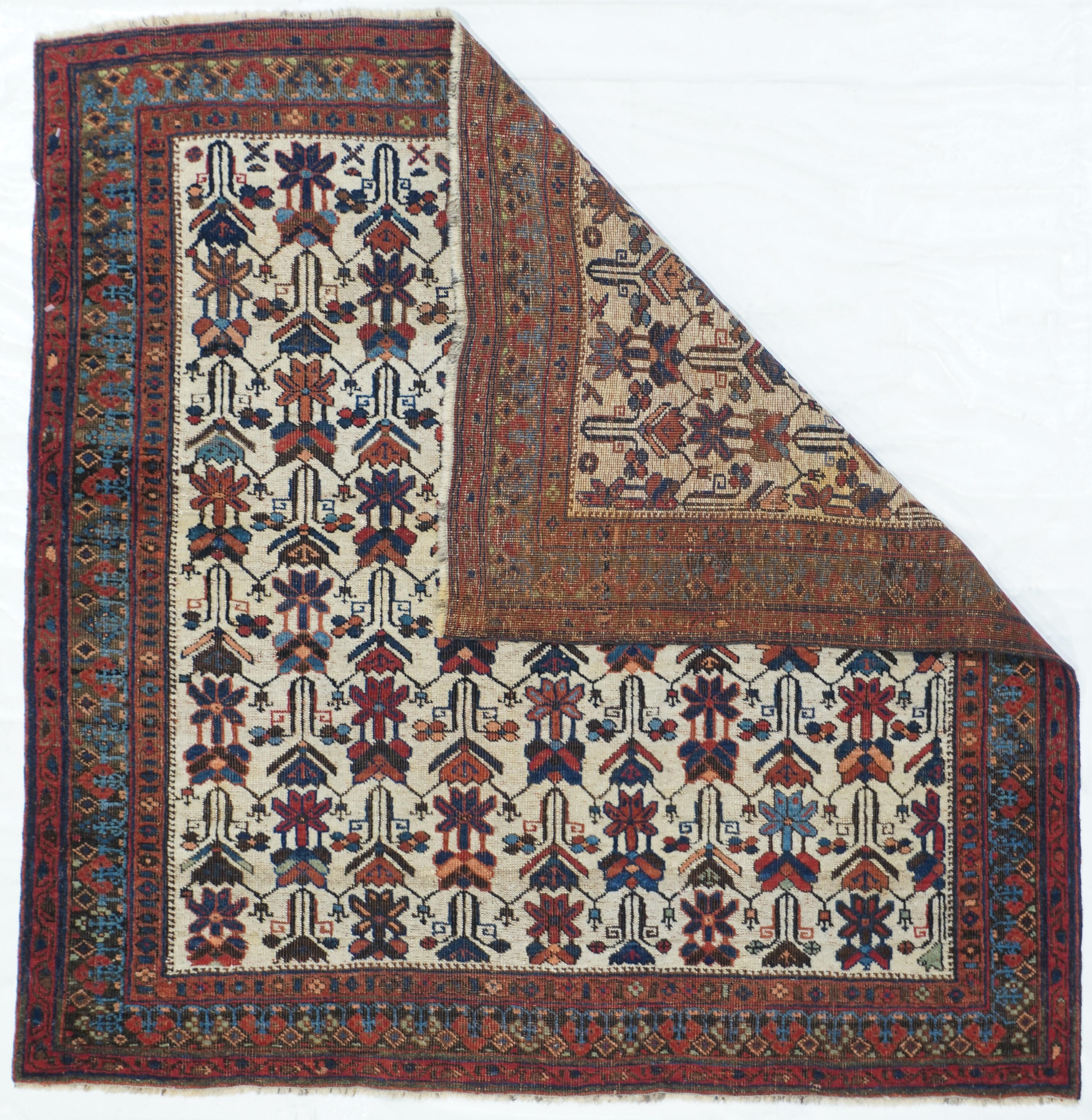 Antique Afshar rug 3'5'' x 3'6''. This SE Persian (Kirman Province) scatter show an off white field with 9 and columns of stylized stacked blossoms and associated leaves. Weaving moved from visual left to right and the tribal weaver did not space