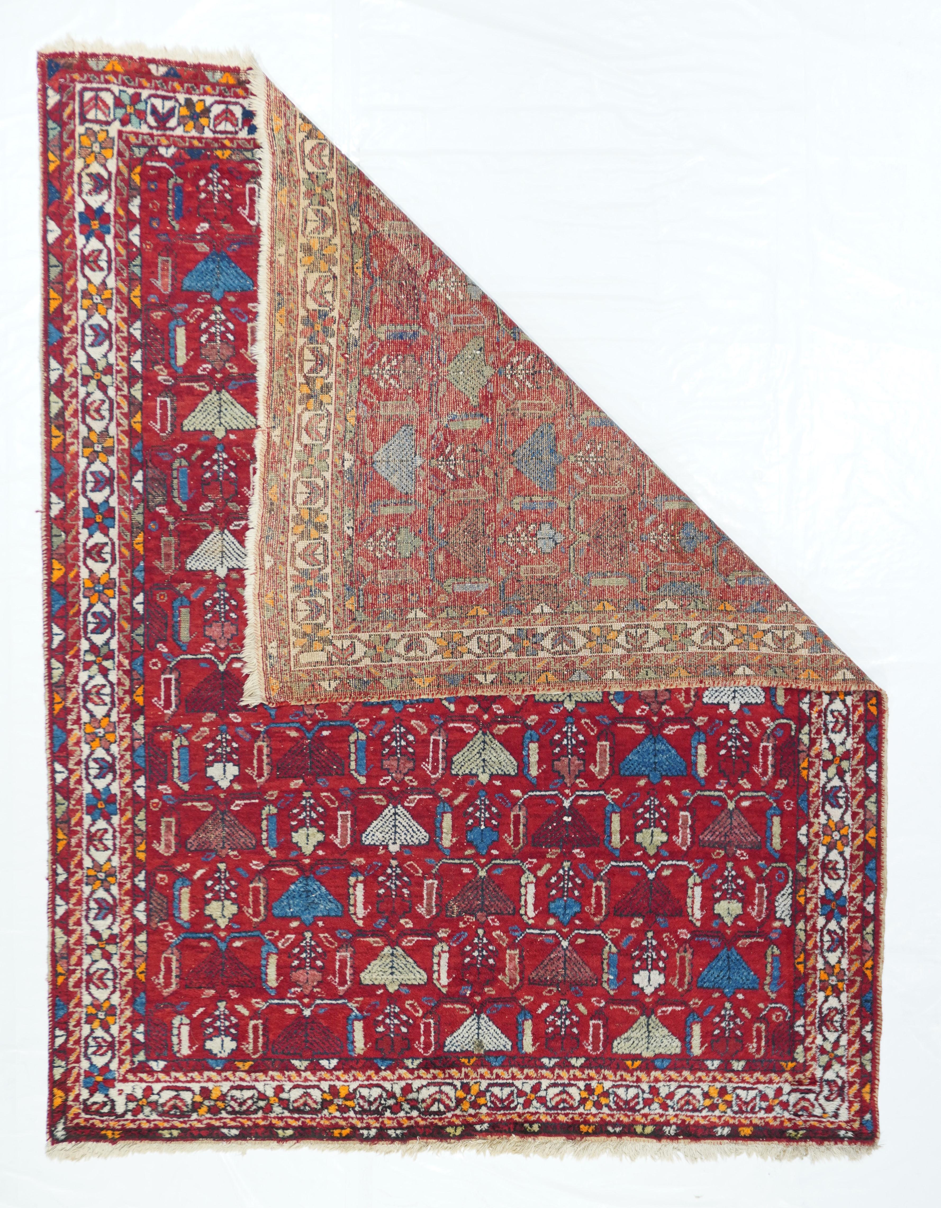 Antique Afshar rug 5' x 6'5''. Thirteen rows of broad tailed peacocks in straw, sand, deep red and medium blue, with flowers between individual birds, run across and up the red field of this tribal SW Persian scatter. Small orange details. Narrow