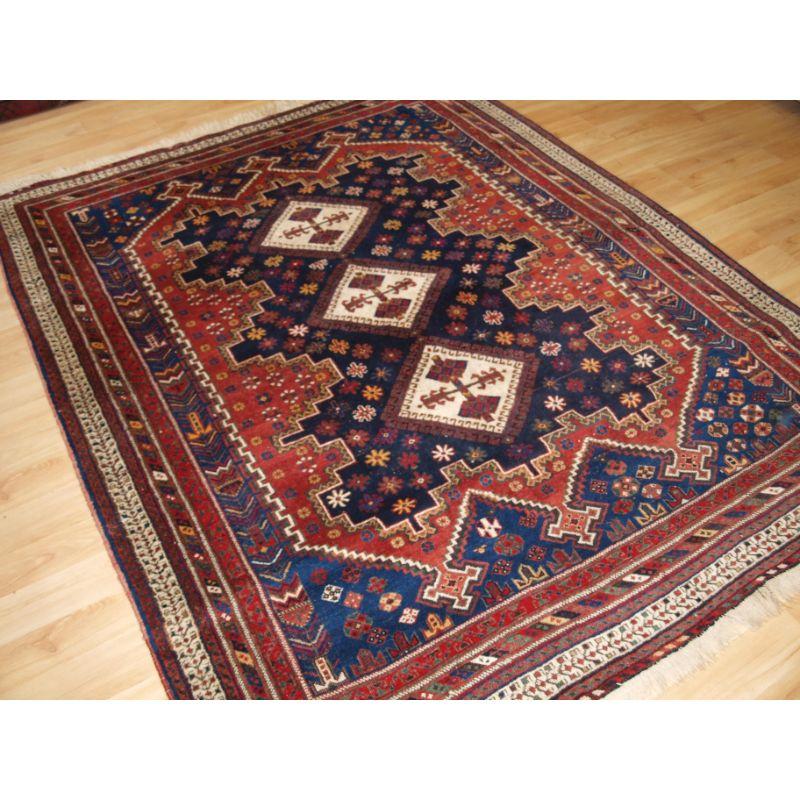 Antique Afshar rug of classic design, with an indigo field containing three ivory medallions. The border is well drawn and typical of Afshar weaving. The rug has superb natural colours throughout.

The rug is in excellent condition with even wear