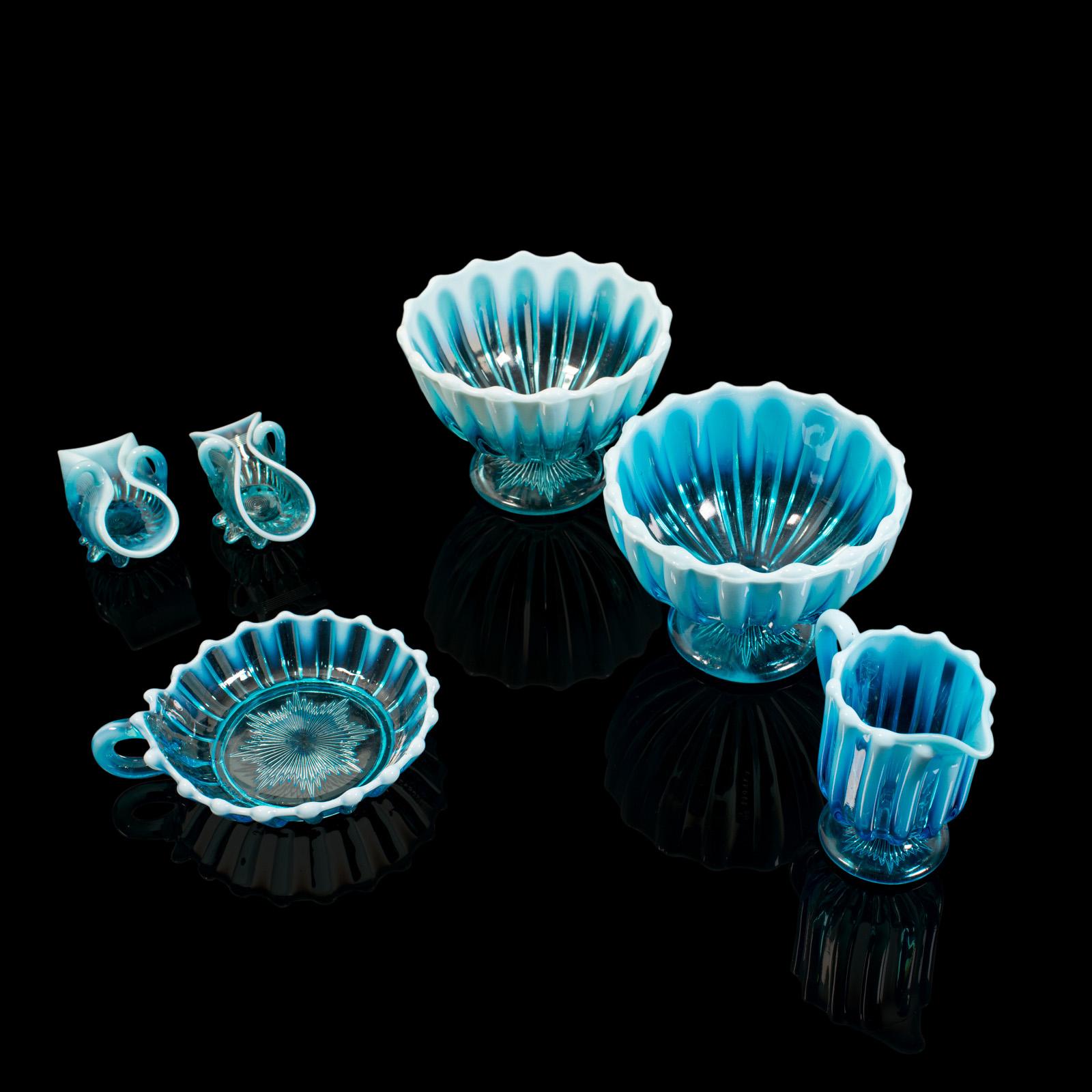 This is an antique afternoon tea service. An English, glass Pearline tea party set by Davidson, dating to the Victorian period, circa 1900.

Radiant serving set with striking blue glass
Displaying a desirable aged patina and free of