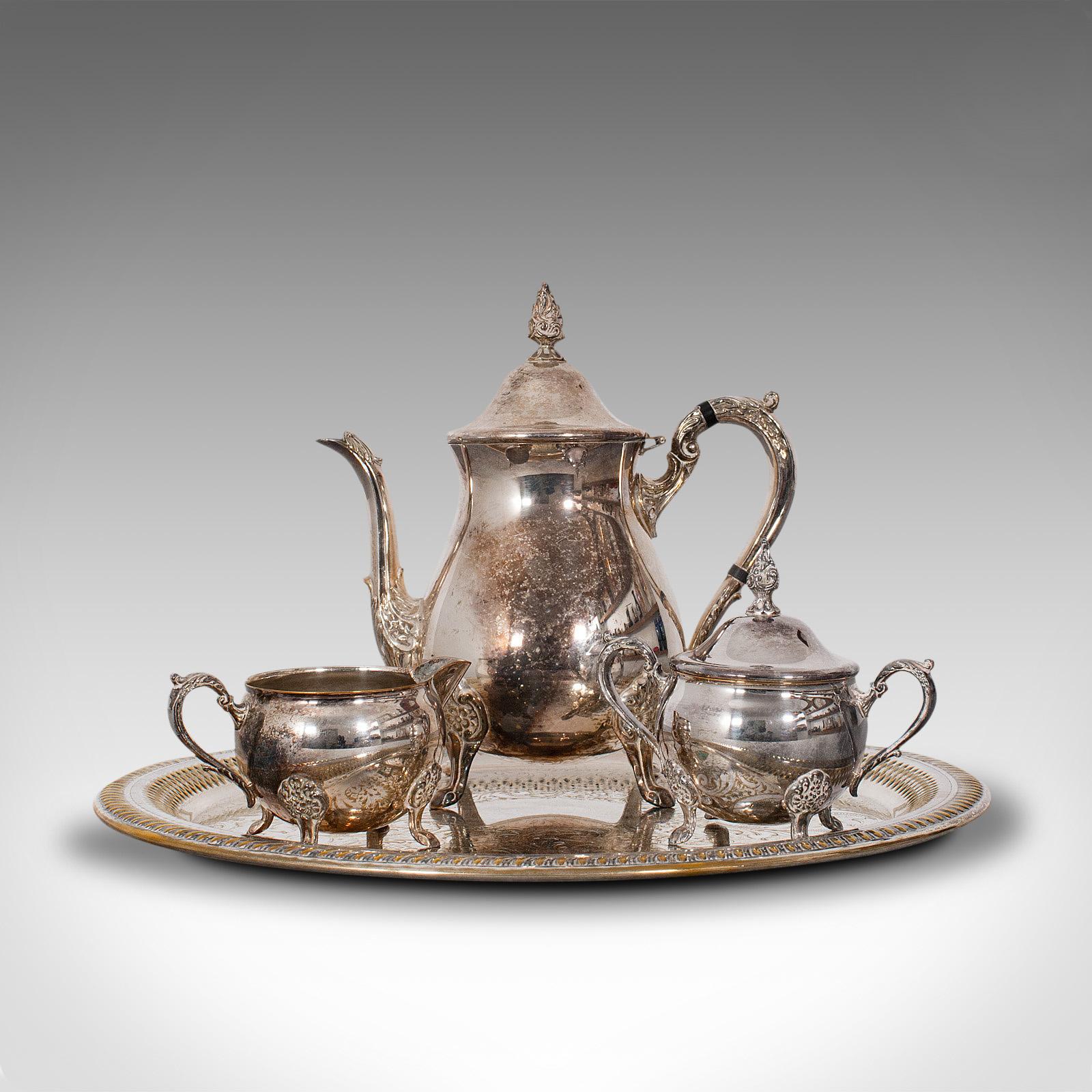 This is an antique afternoon tea service. An English, silver plated 3 piece set with serving tray, dating to the Edwardian period, circa 1910.

Attractive service with engraved detail
Displays a desirable aged patina, wonderfully natural