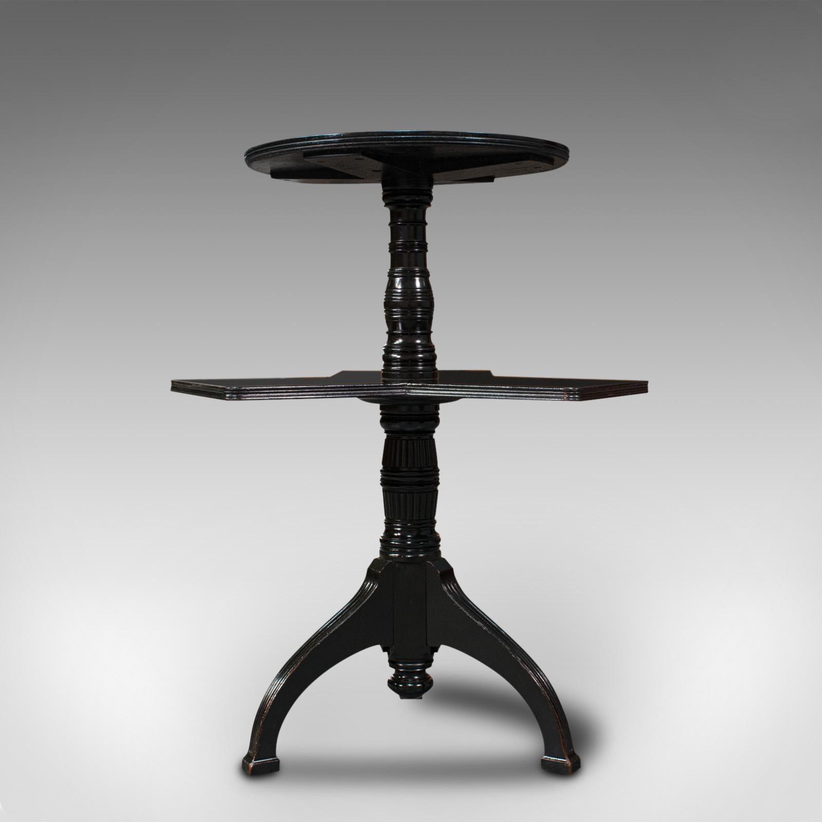 This is an antique afternoon tea table. An English, ebonised mahogany cake stand or occasional table, dating to the Aesthetic period, circa 1880.

Captivates with its pleasingly unusual form
Displaying a desirable aged patina and in good