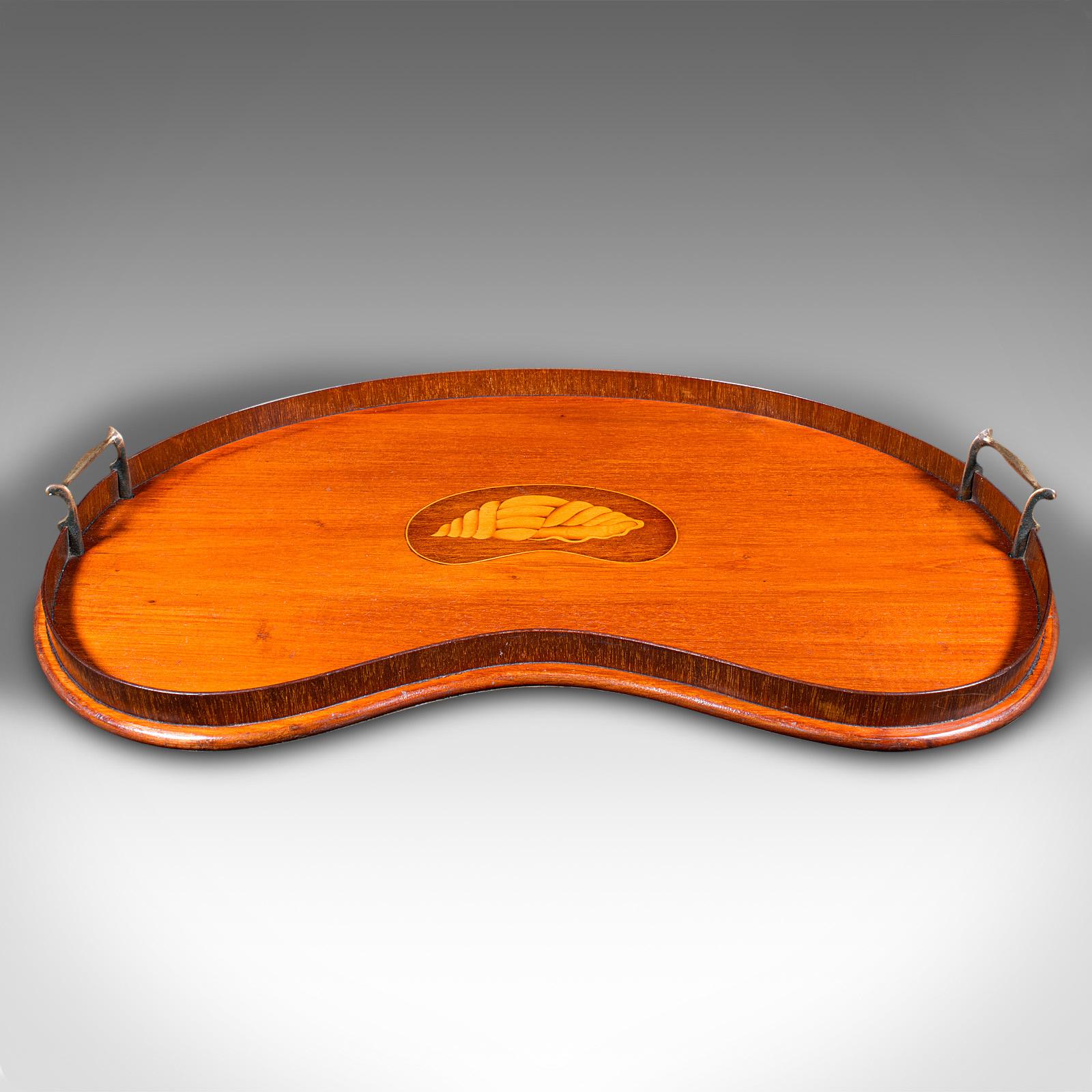 This is an antique decorative afternoon tea tray. An English, walnut and brass serving platter, dating to the Edwardian period, circa 1910.

Wonderful kidney shaped serving tray with great colour
Displays a desirable aged patina and in good order