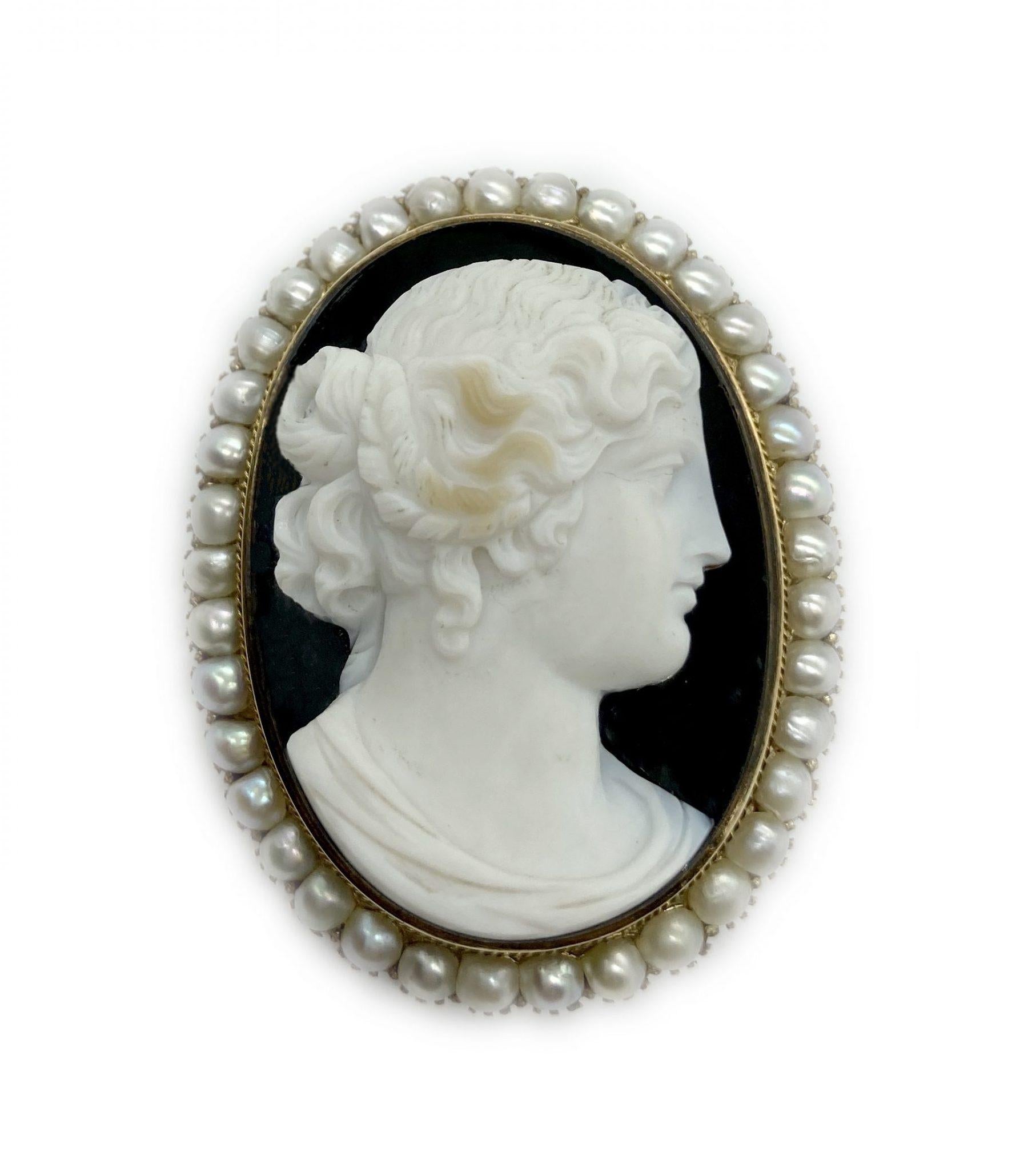An elegant antique cameo brooch featuring a profile of a lady, encircled with pearls.