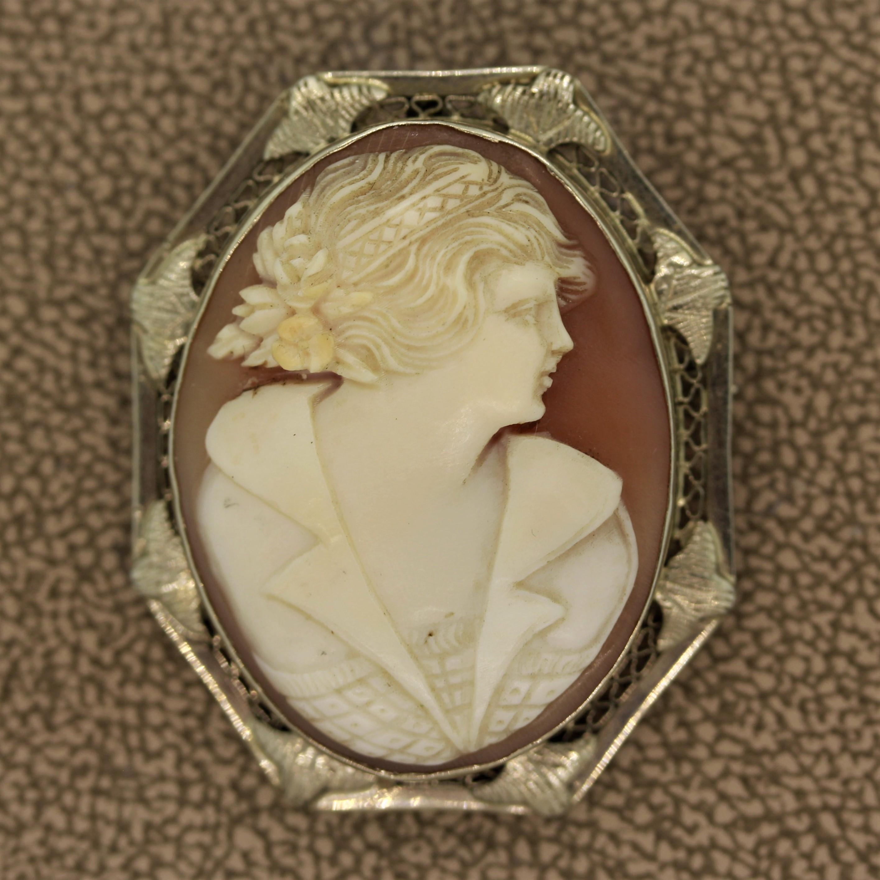 A classic cameo depicting a regal woman with a bouquet of flowers in her hair. The frame is made in 14k white gold with filigree made by hand. Can be worn as a brooch or attach a chain to the bail and wear it as a pendant.

 

Length: 1.3
